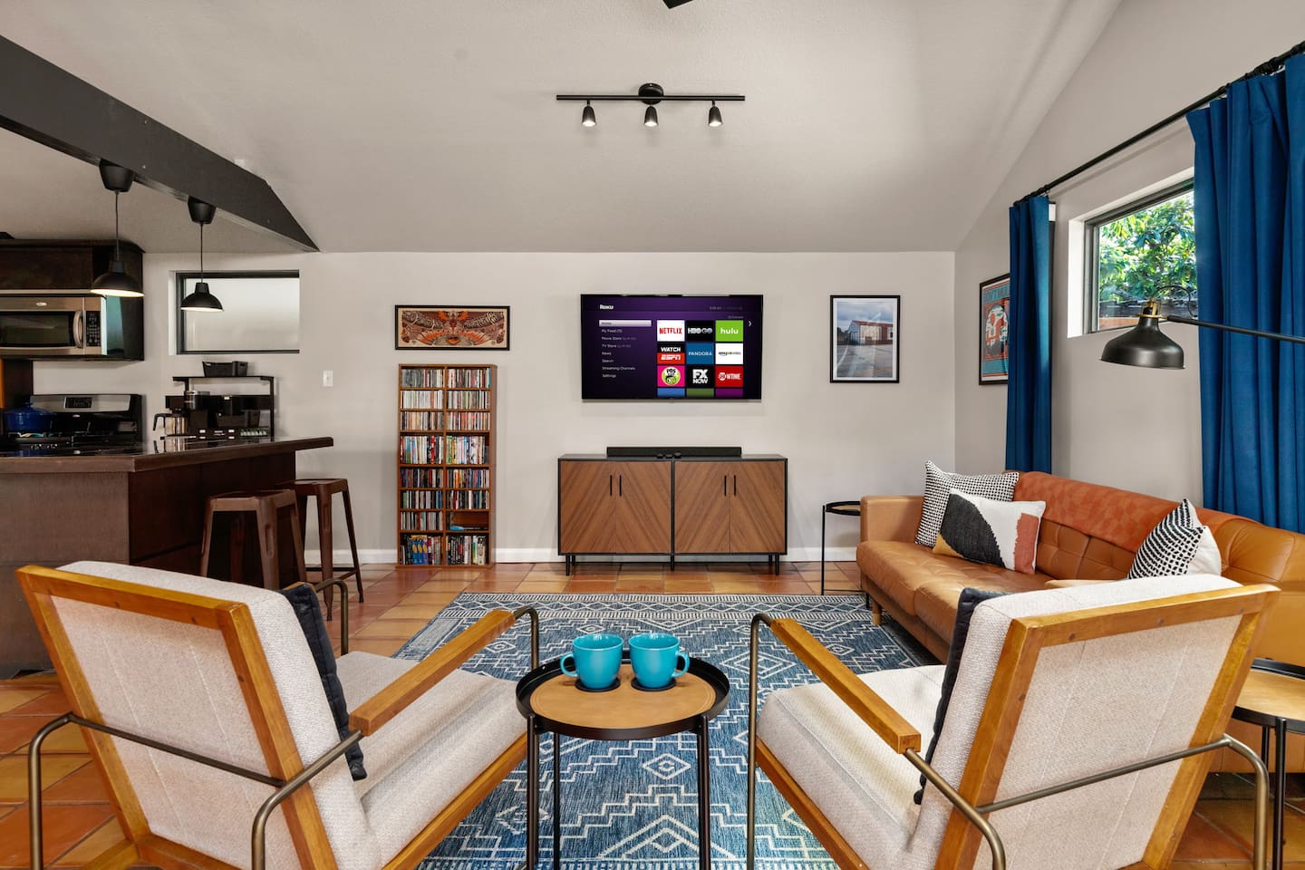 Living area: Love seat, couch, and 50 inch Smart TV with DVD player