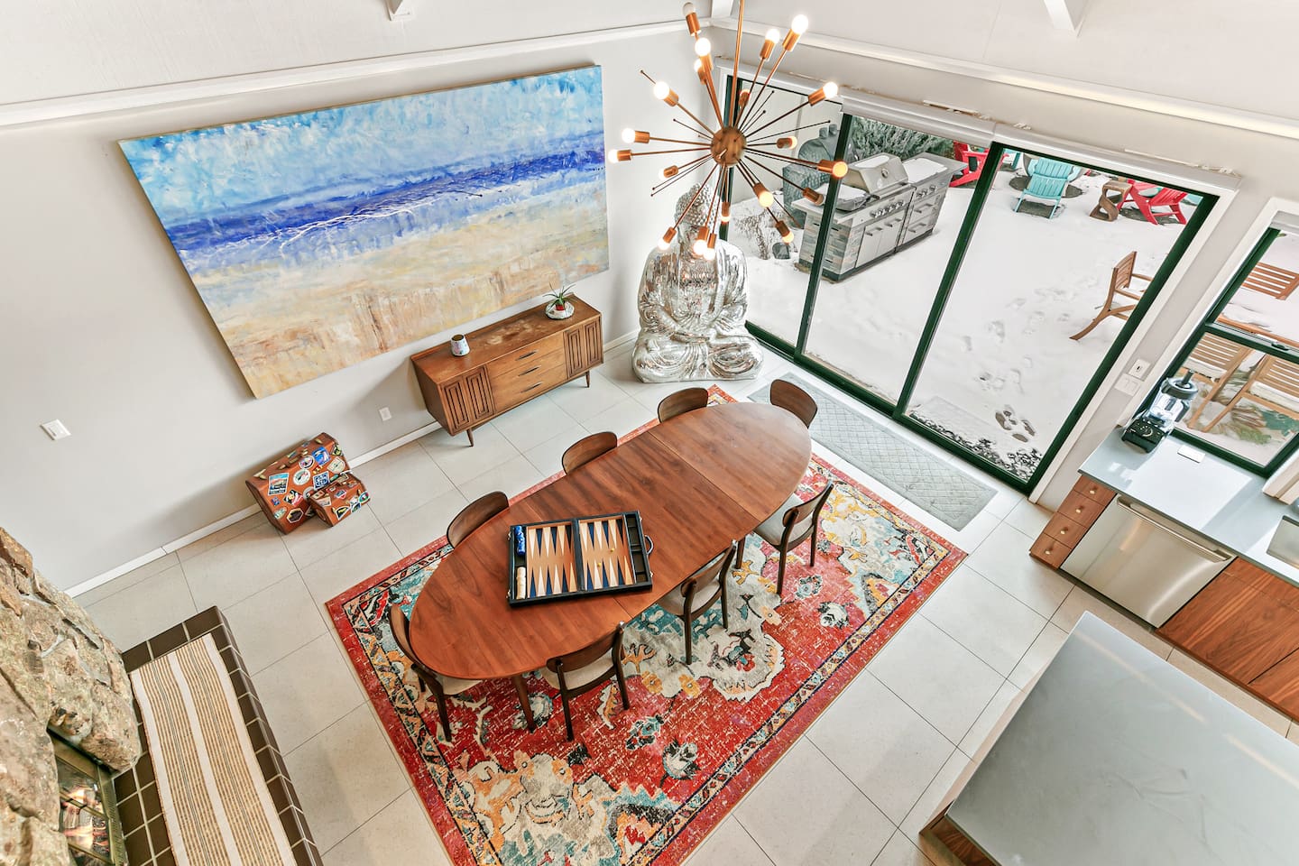 The dining area comfortably seats nine guests, featuring an expandable table and a two-sided fireplace. Its proximity to the fully equipped kitchen, Living Room 1, and the Back Patio adds convenience to mealtimes and social gatherings.