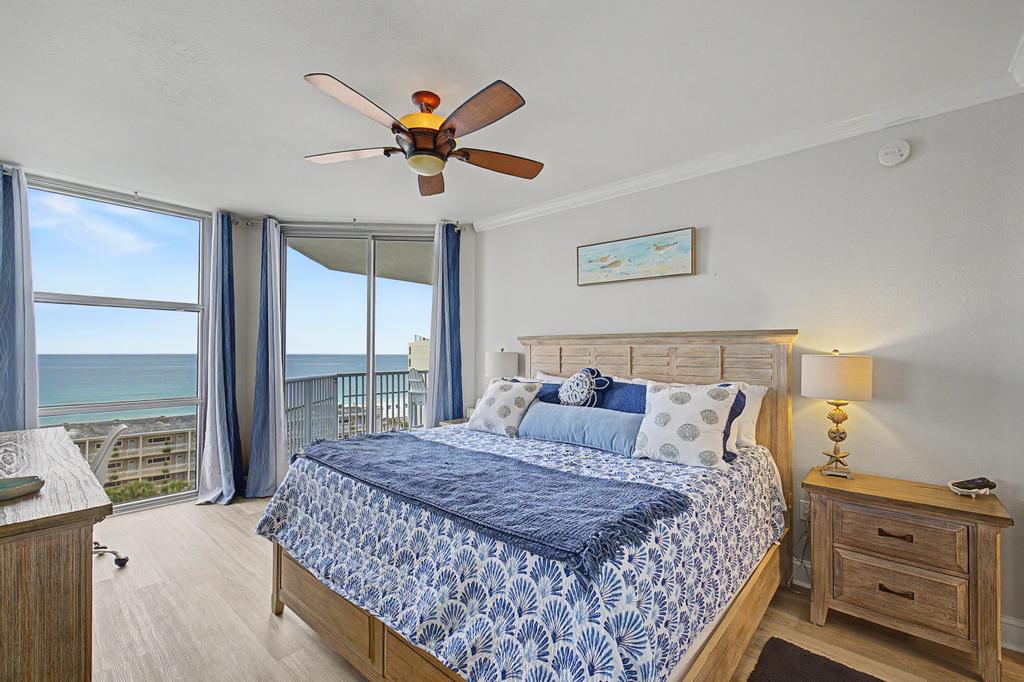 Master bedroom, access to balcony and beautiful Gulf view facing east. Black out curtains ensure ample rest.