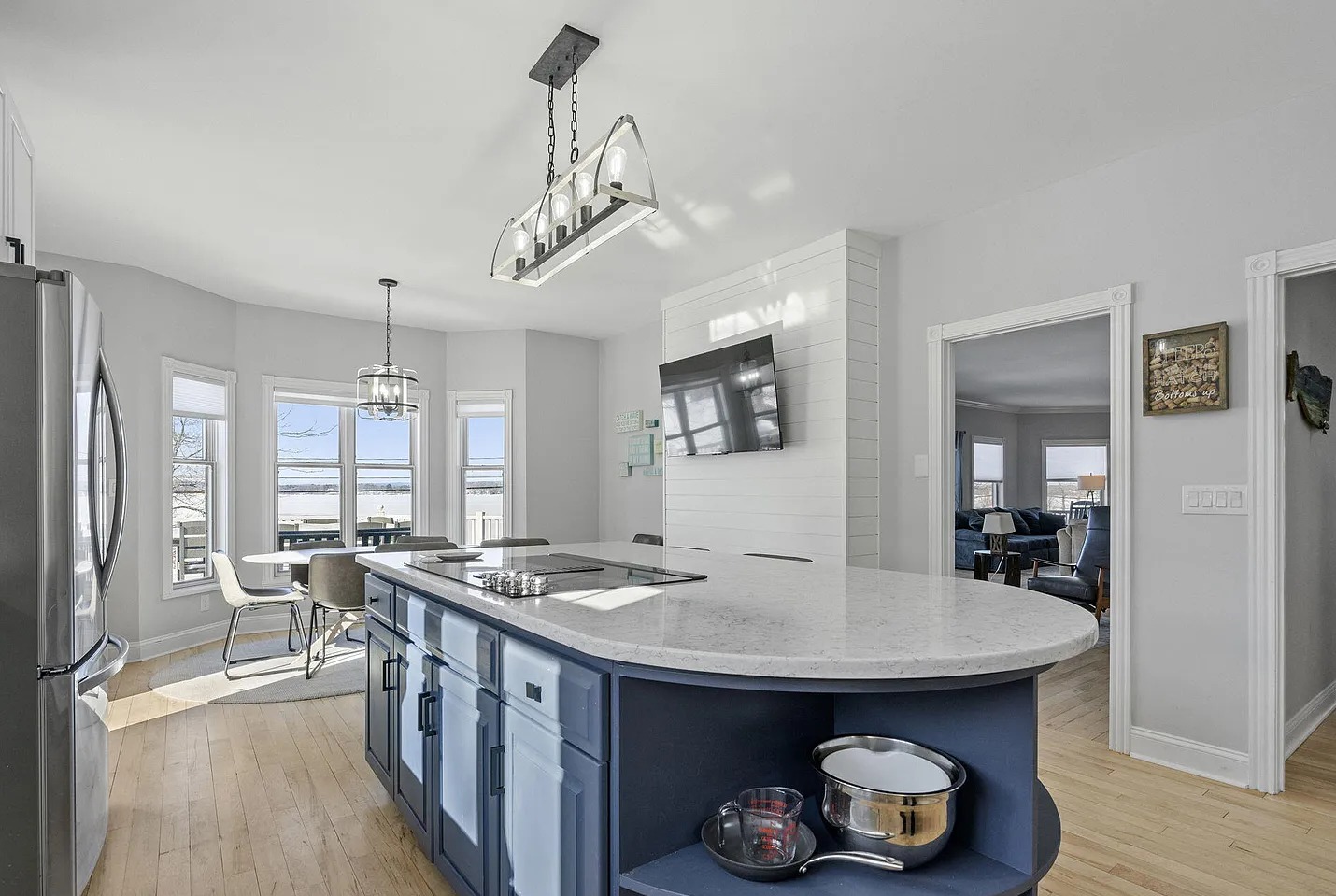 This open, light-filled kitchen combines spacious island seating, a charming breakfast area, ad breathtaking lakefront views from nearly every angle.