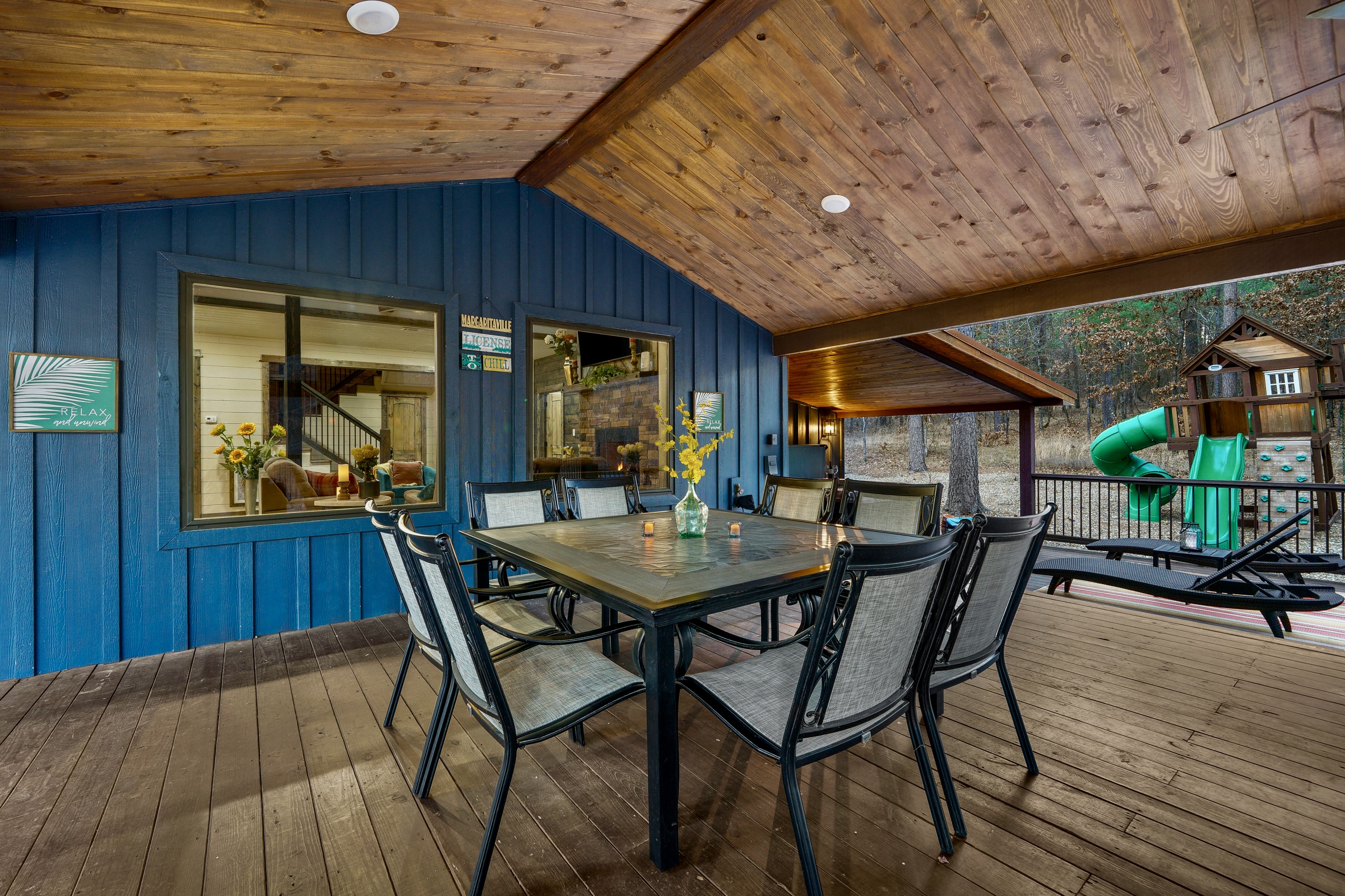 Enjoy meals and gatherings under the fresh air on the expansive deck with this large table.  Comfortably seats 8, right next to the fireplace and a large TV. 