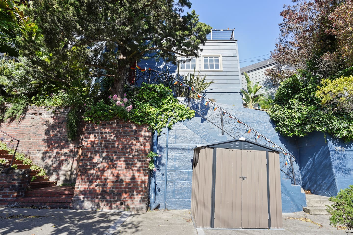 Outdoor view of the apartment; garbage is stored in the shed below