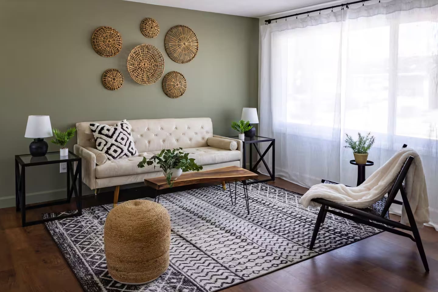 Sunlight pours in through sheer curtains, lighting up a space made for lounging.