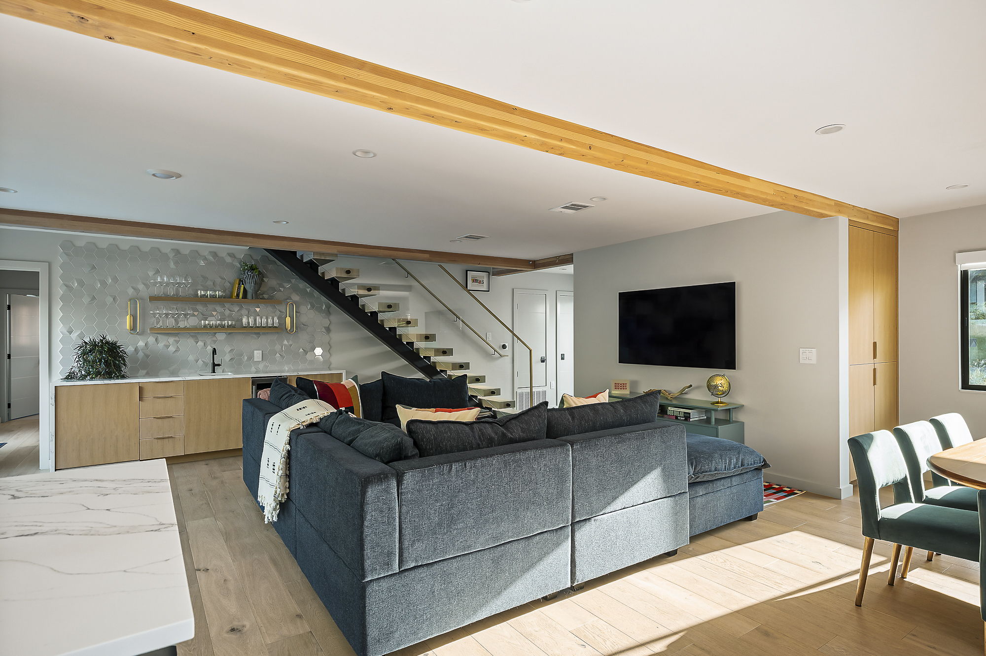 Natural light floods the area through expansive sliding glass doors that offer a seamless connection to the outdoors.