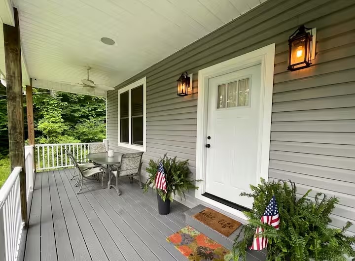 front door and deck with view of lake