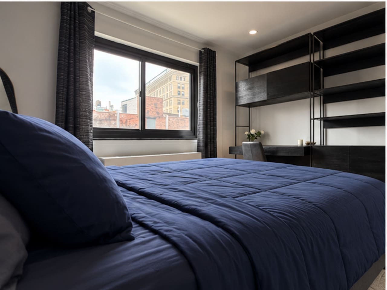 Bedroom with stunning New York City skyline views — wake up to Lower Manhattan in our Little Italy 2-bedroom rental