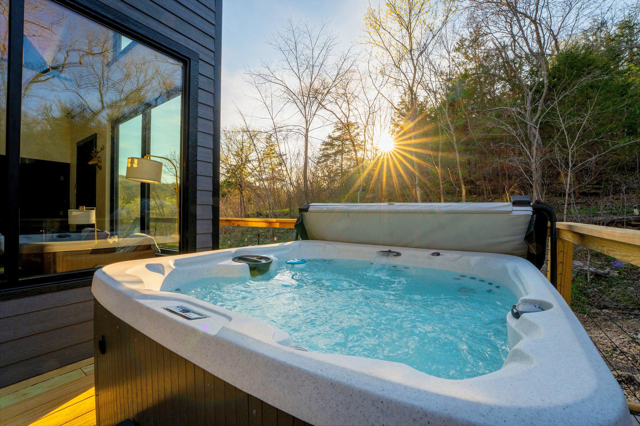 Soak under the trees and over the flowing creek in the hot tub perched on the private deck while the surrounding forest settles into evening