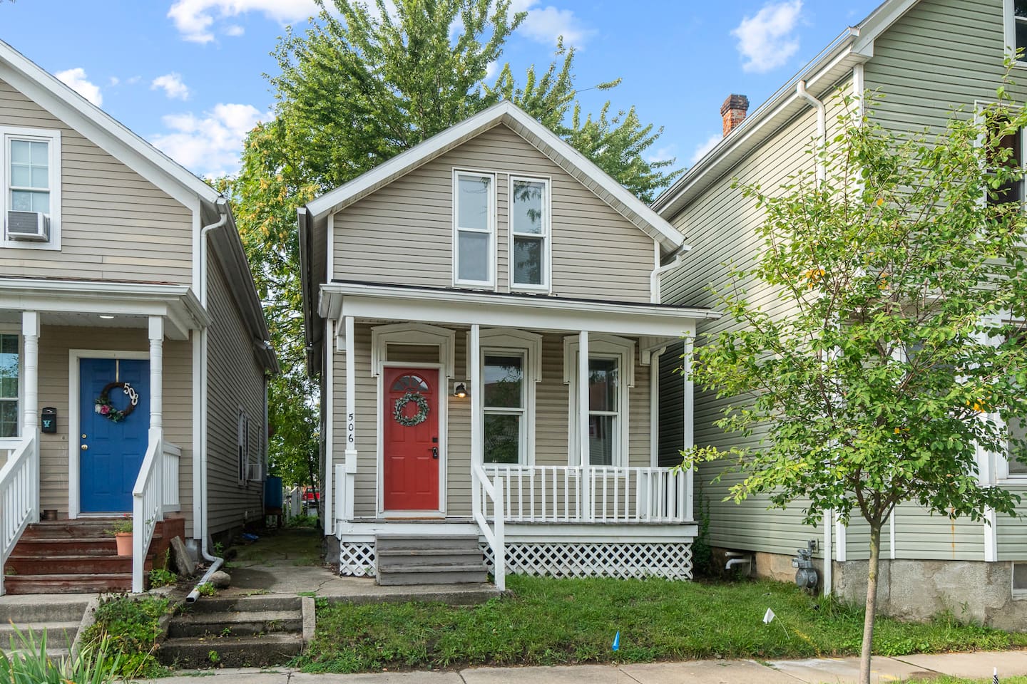 House exterior with mature trees and front porch.