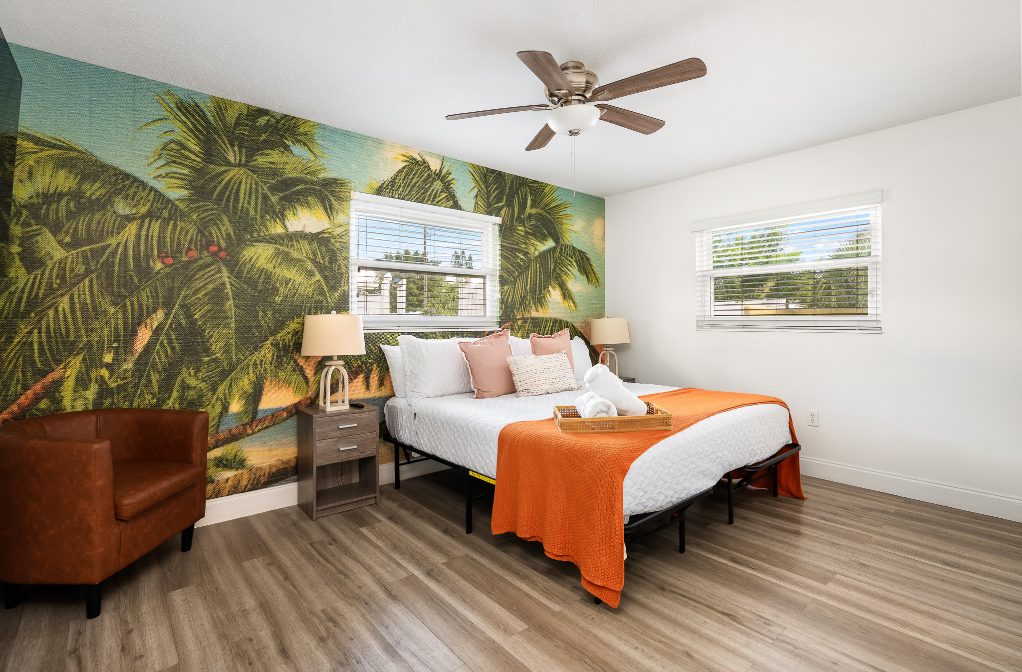 The Orange Room (primary bedroom) has a spacious king bedroom. Golden hour hits different when your whole room feels like sunset. 🧡 Start your morning with palm trees and end it in paradise.
