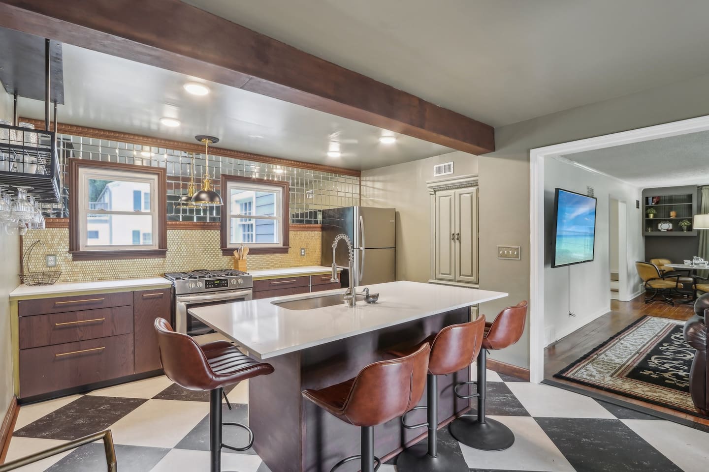  Cook and connect in the roomy kitchen, where bar seating, generous counter space, and warm finishes make group time easy.