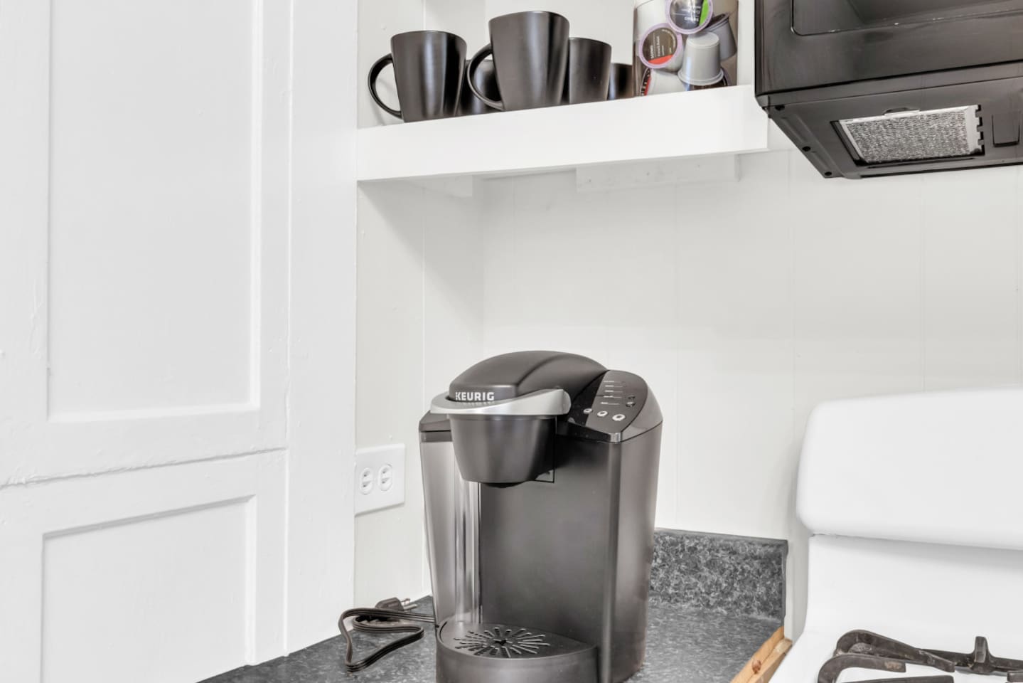 Coffee station with Keurig and mugs for your morning brew.