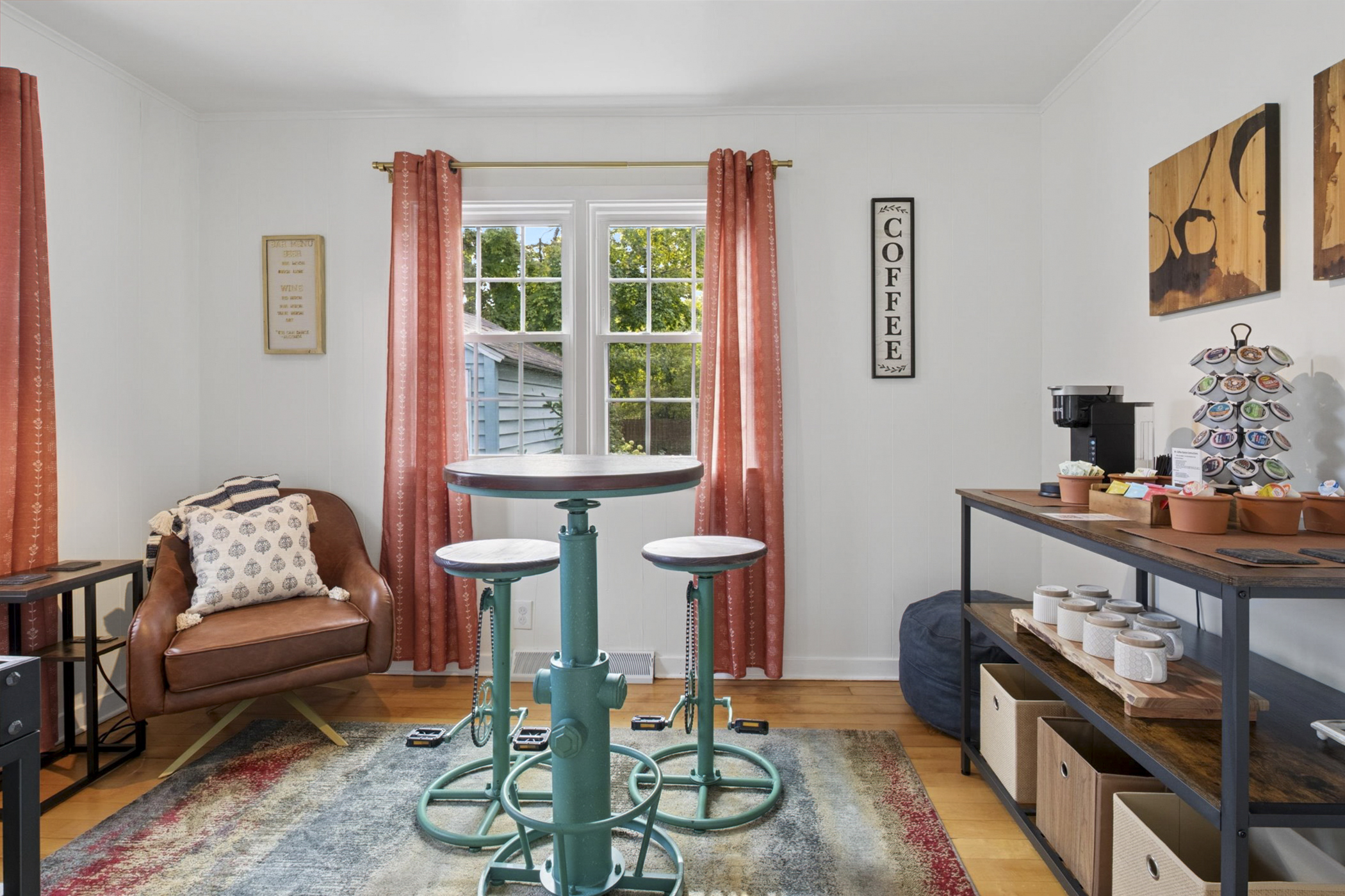 Start your day in style—our Sunshine Lounge features a high-top table and unique bike-pedal stools, perfect for morning coffee, family games, or a cozy hangout near Notre Dame.