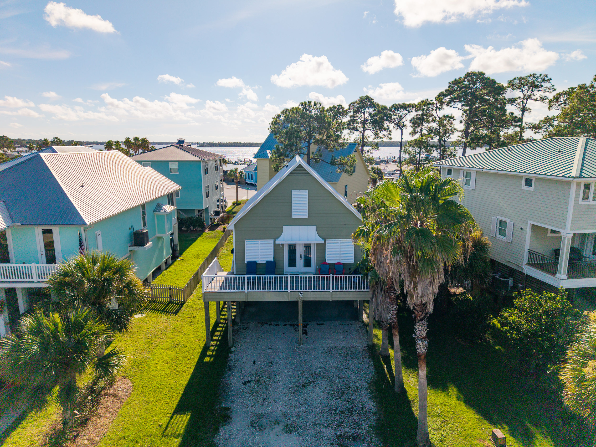 An aerial view shows just how close the home sits to Bear Point's waterways — a favorite spot for boating, fishing, and kayaking.