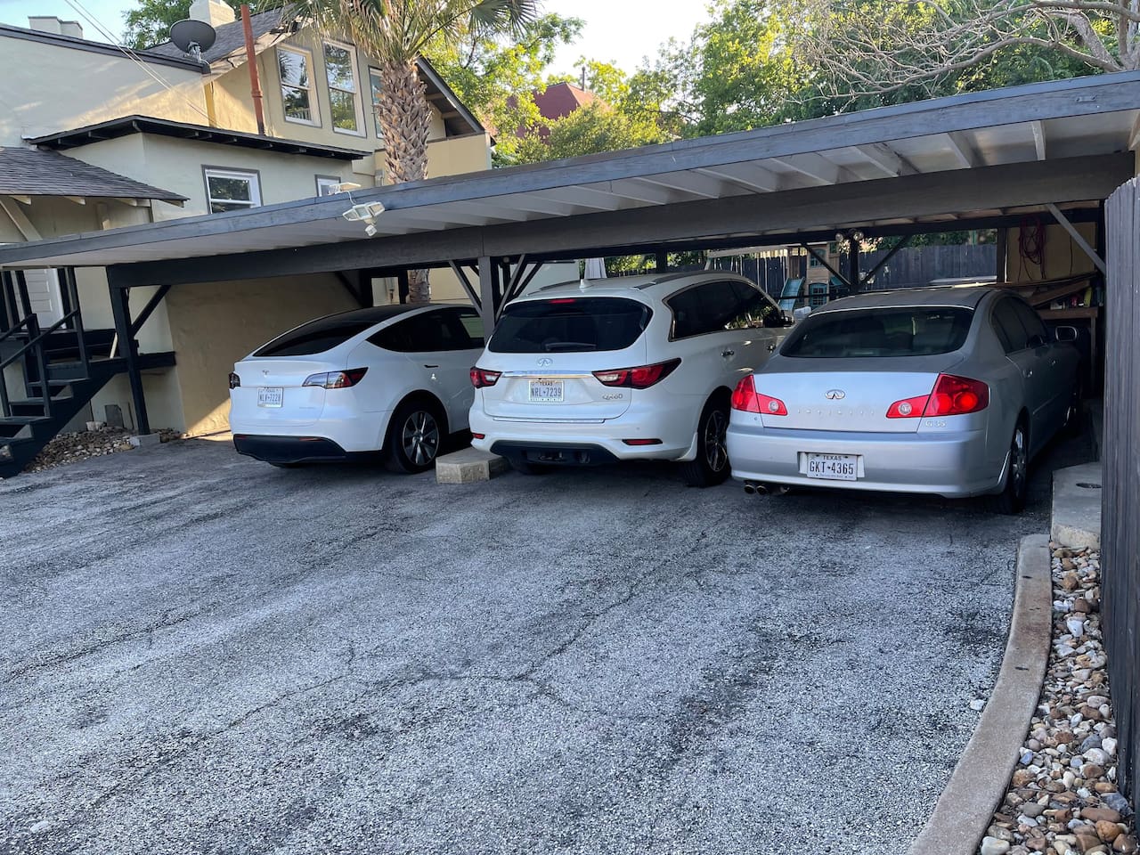 Large parking area with 3 covered spaces and room for many more.