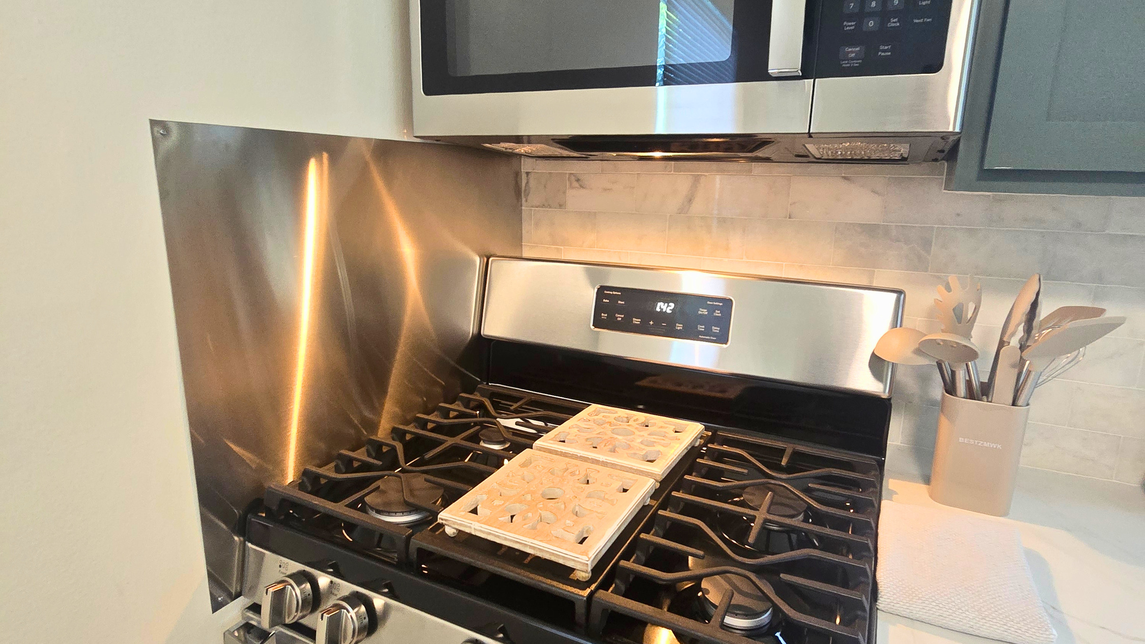 Five-burner gas range, stainless appliances, and everything you need to cook at home.