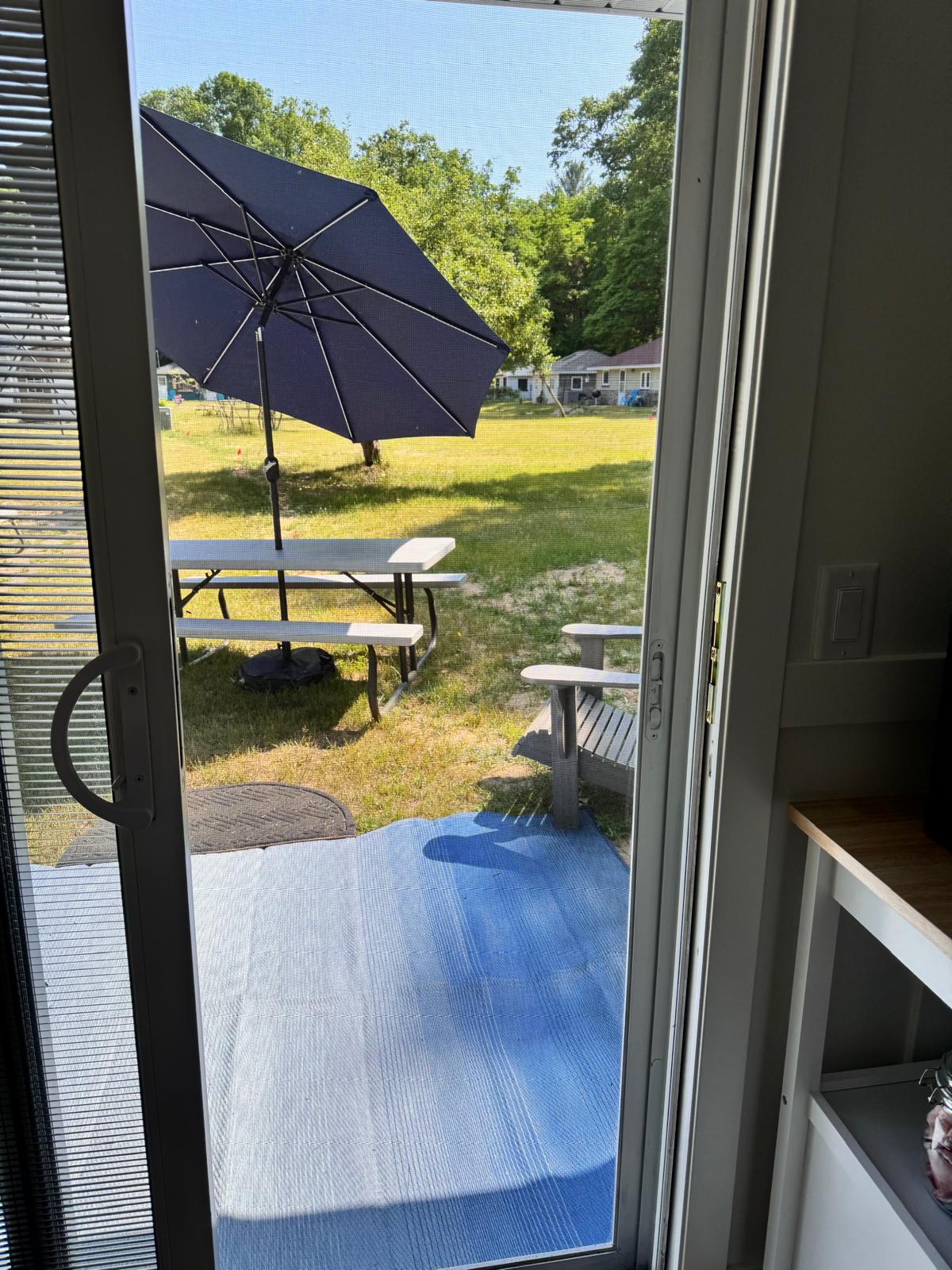 Step through this entrance to reach the side yard, where a fire pit invites you to relax and enjoy warm, cozy