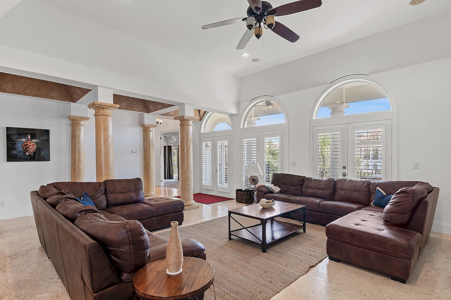 Spacious living area with high ceilings and abundant natural light