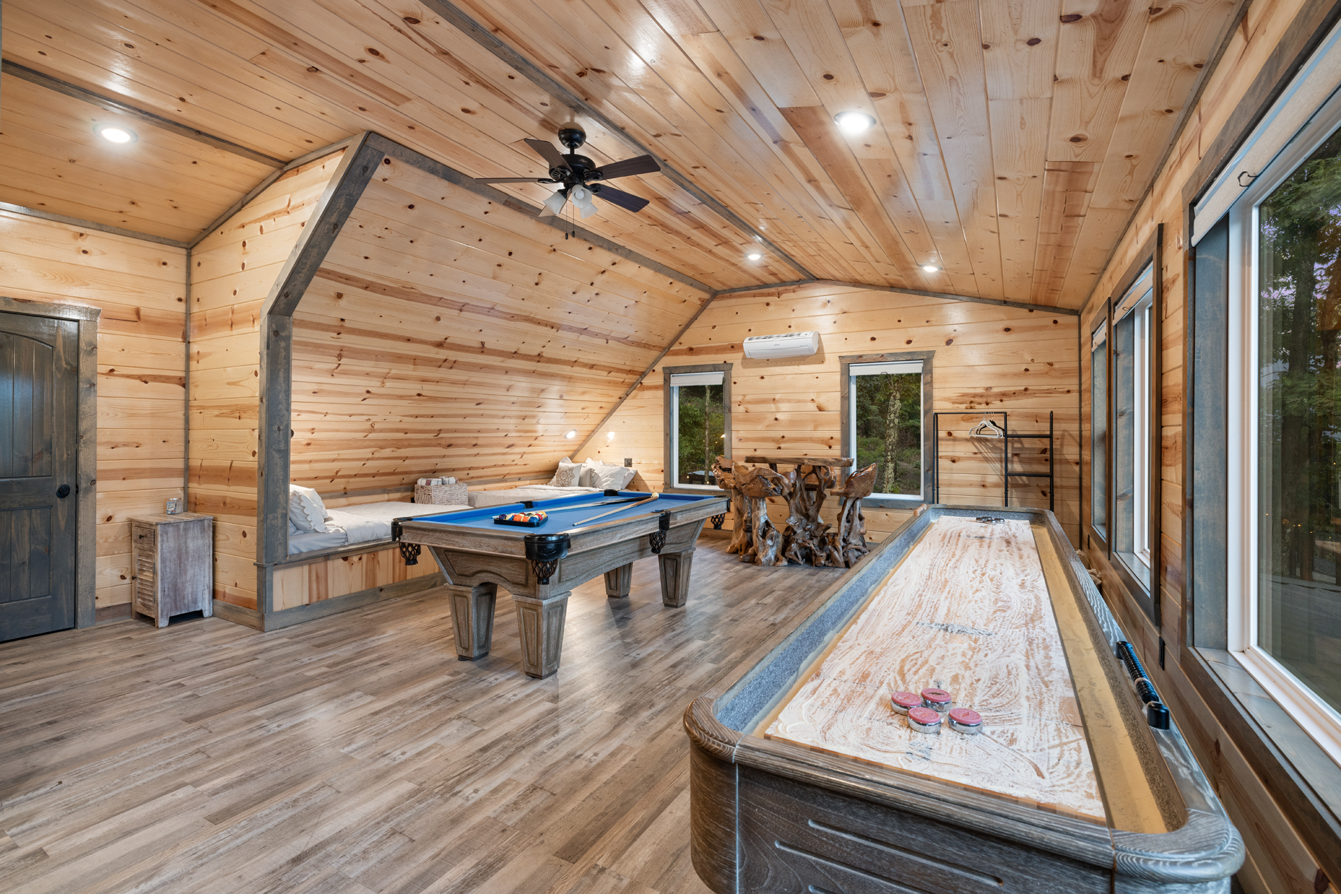 Spacious loft game room featuring pool table, shuffleboard, and gathering space
