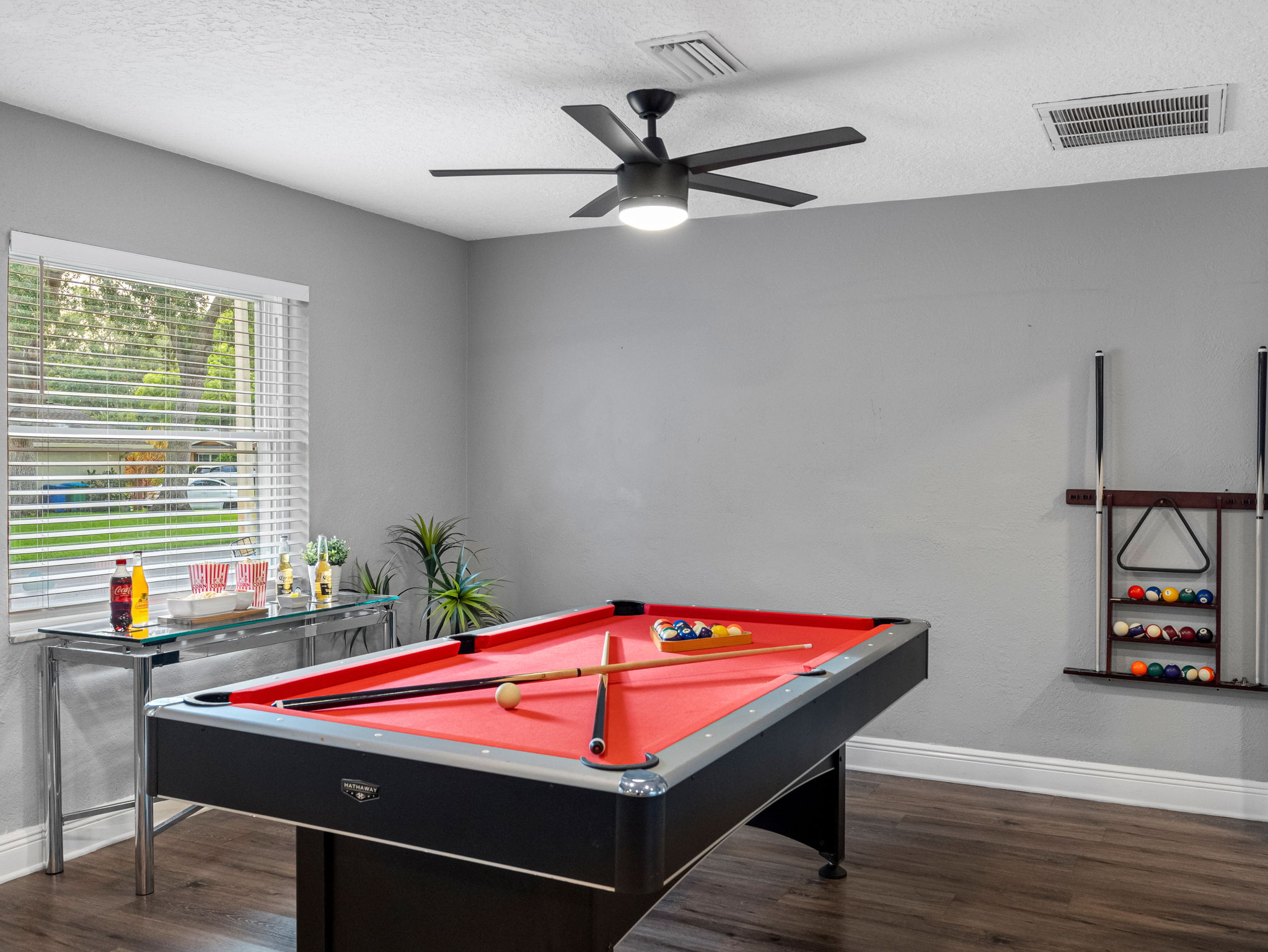 Whether you're sinking shots on the red felt pool table or battling it out in ping pong, this game room is built for endless entertainment.