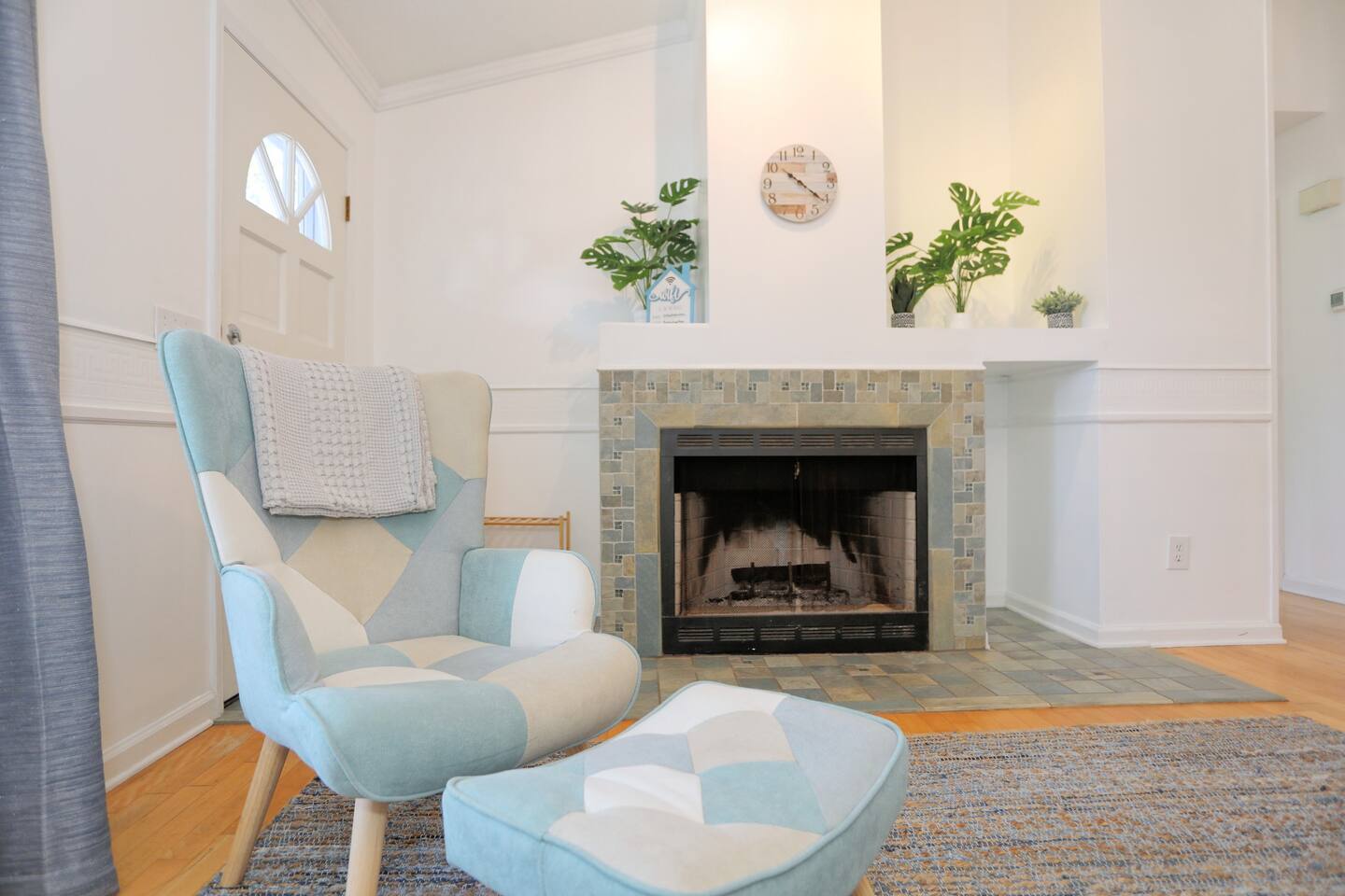 Relax in the bright and spacious living room with high ceilings, abundant natural light from large windows, cozy seating, and a smart TV for your entertainment.