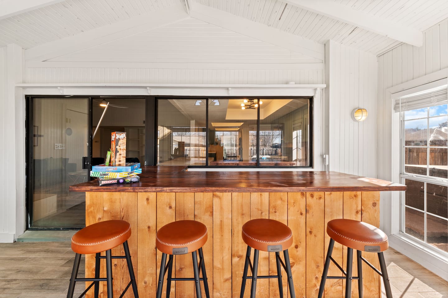 Host happy hour in the sunroom—your private indoor bar with seating for four and classic board games for laid-back fun.