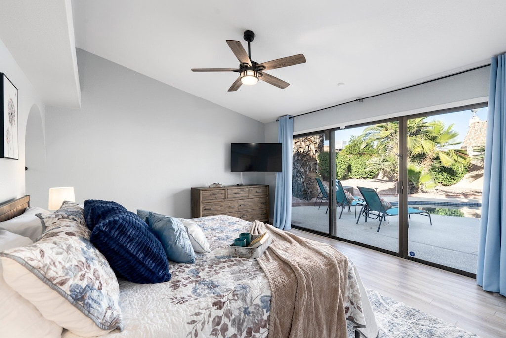 Primary King bedroom with luxurious linens and a wonderful view of the backyard.