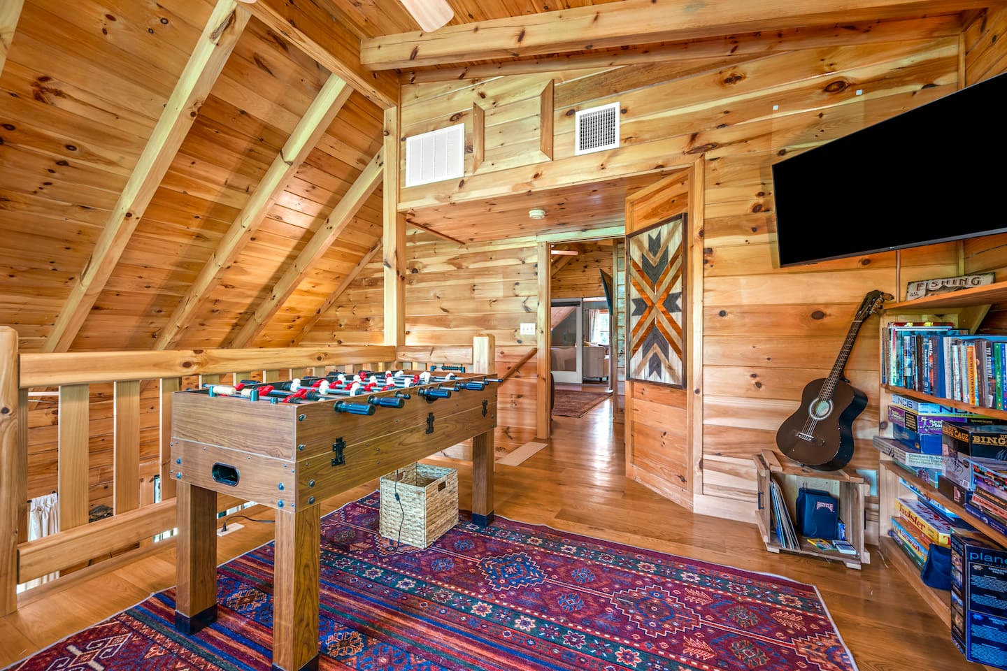 Loft game area with foosball table, TV, board games and movies. 