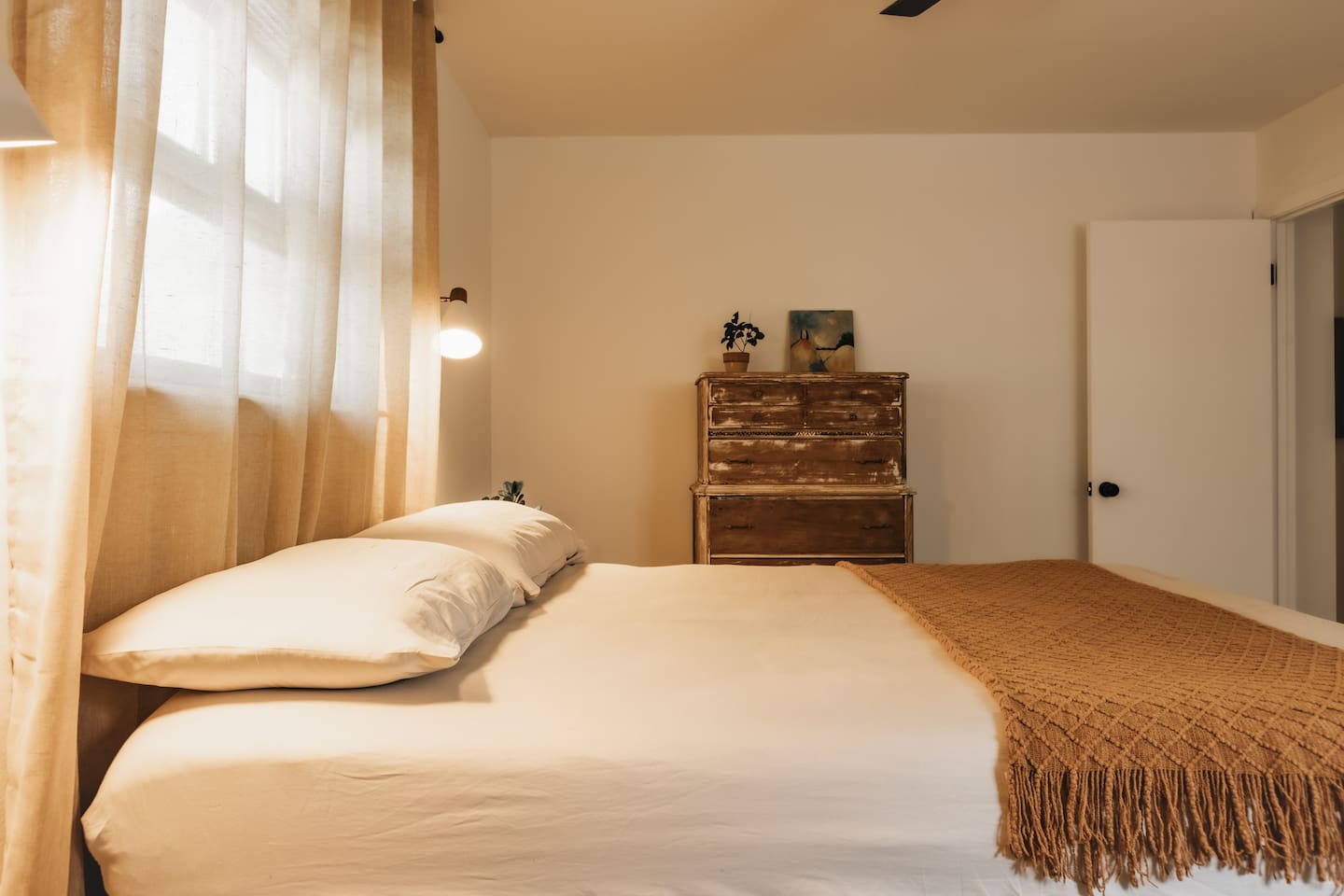 bedroom 1 with comfy queen bed, work desk, and antique deco