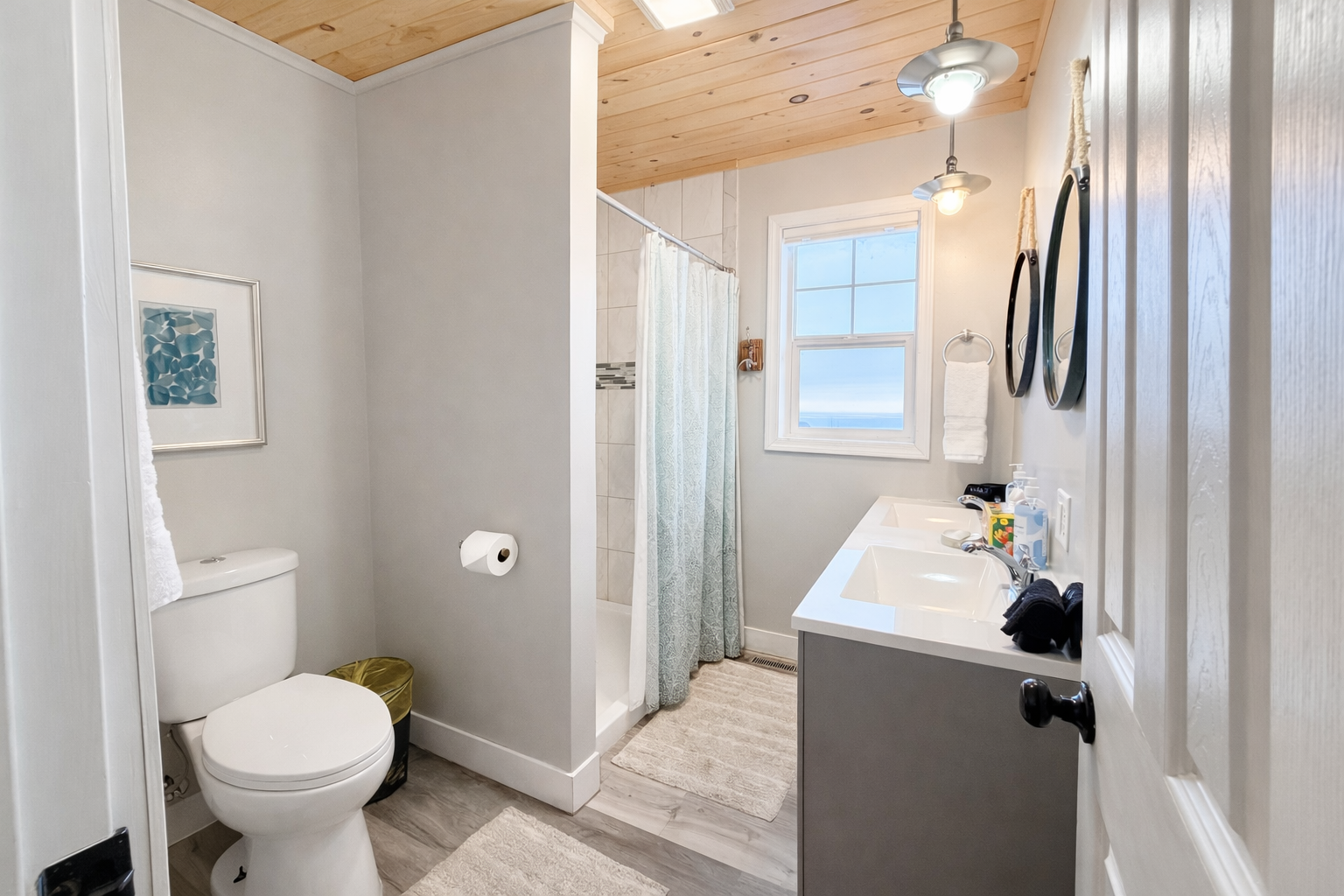 As you enter, the bathroom opens up with a clear view of the walk-in shower and window drawing your eye straight to Lake Superior.