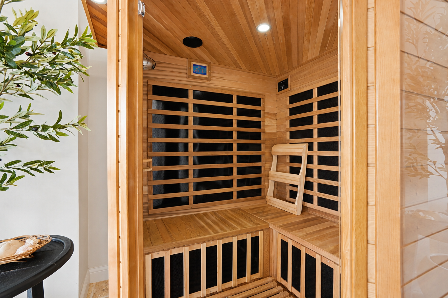Unwind and recharge in the private infrared sauna, thoughtfully designed with warm wood finishes and spacious bench seating. 