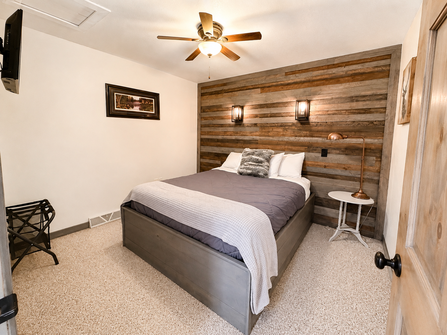 Cozy private Queen bed bedroom with rustic wood accents, comfortable furnishings, and a peaceful atmosphere for resting after a day of ATV riding, snowmobiling, hiking, or exploring Birchwood.