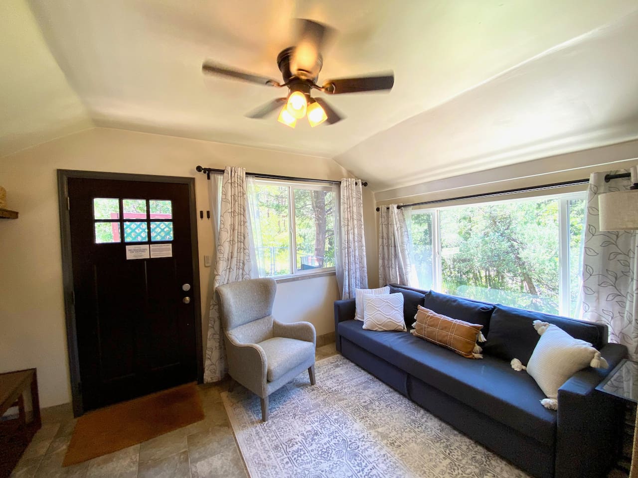 Sunroom located off the front door.  The couch folds out to a queen size bed.  Close the doors and curtains for complete sleeping privacy.