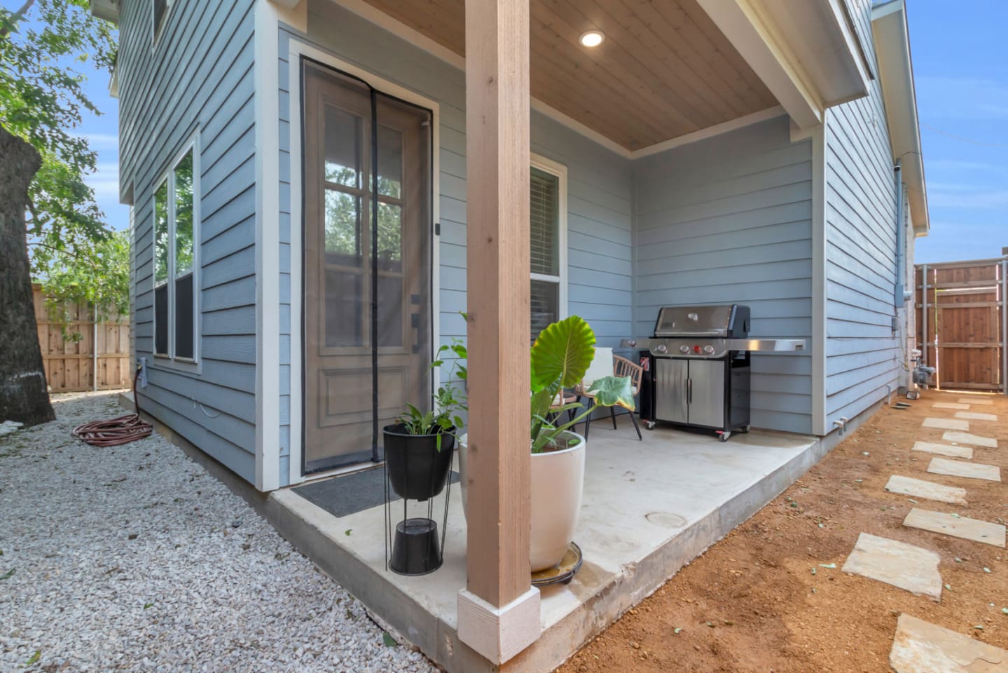 Covered patio with grill for outdoor dining and entertaining.