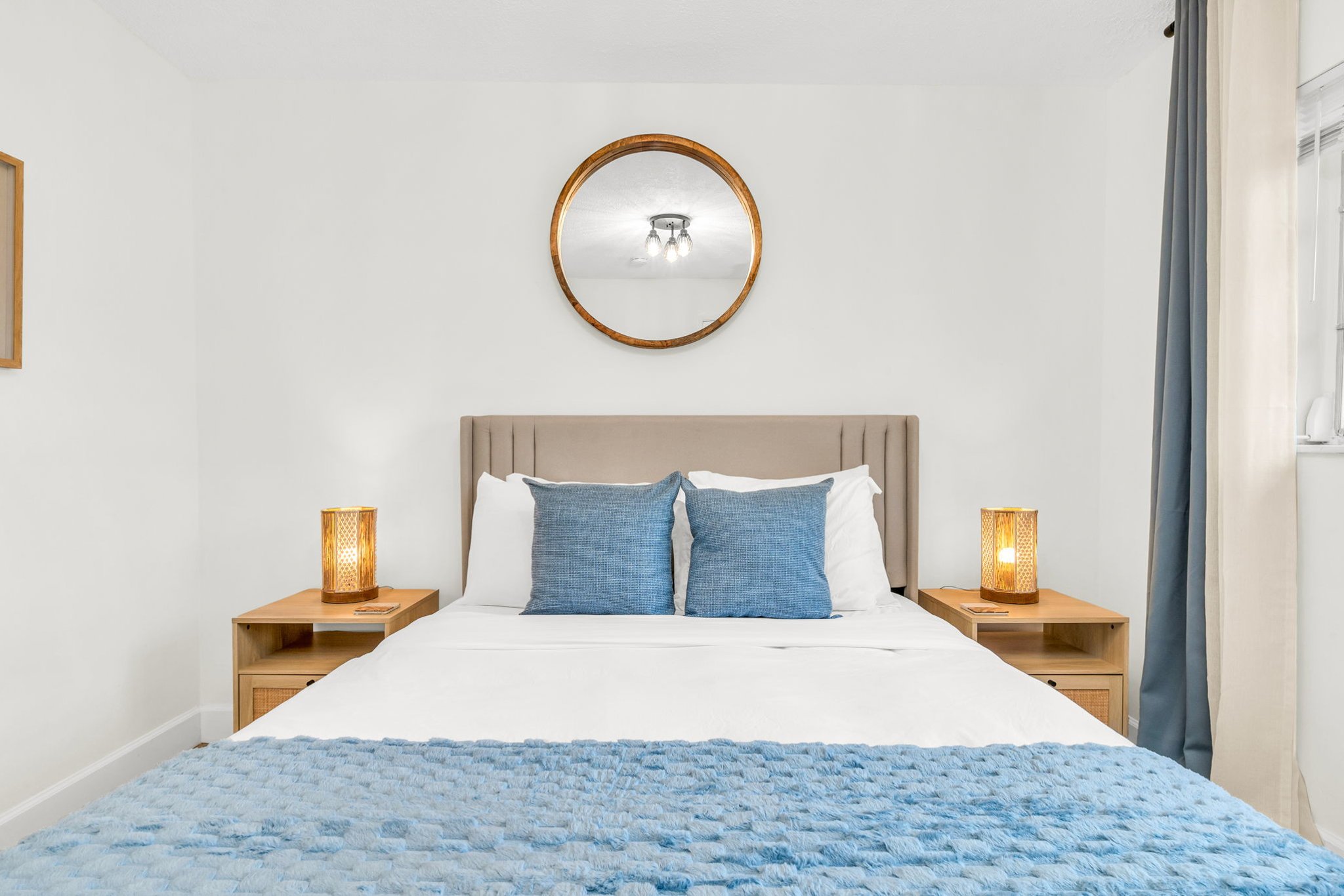 2nd Bedroom: A bright and welcoming retreat featuring a plush queen bed, soft layered linens, and coastal-inspired décor. This room offers ample storage, warm natural light, and a peaceful atmosphere perfect for a restful night’s sleep.