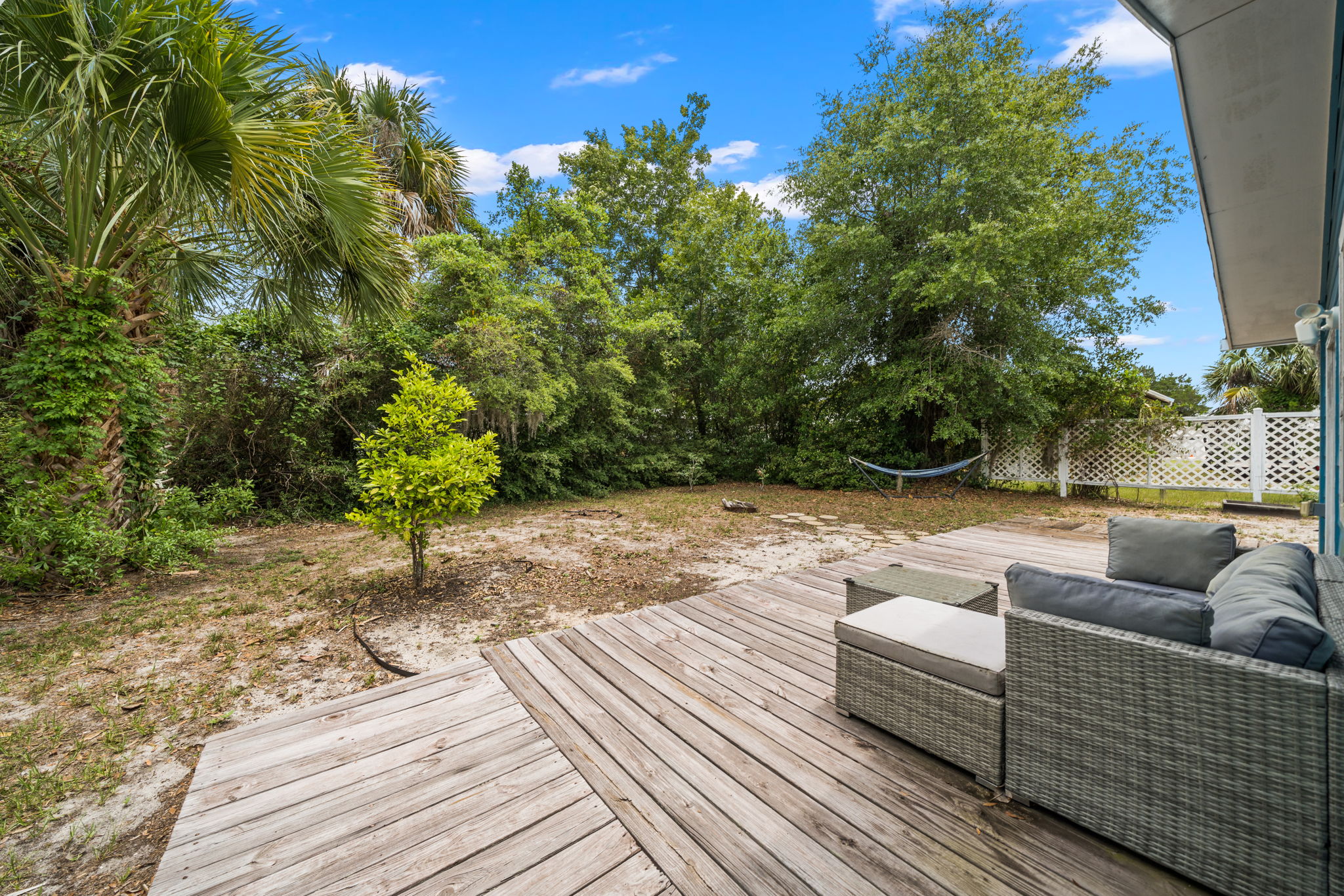 Outdoor seating overlooking the spacious private backyard
