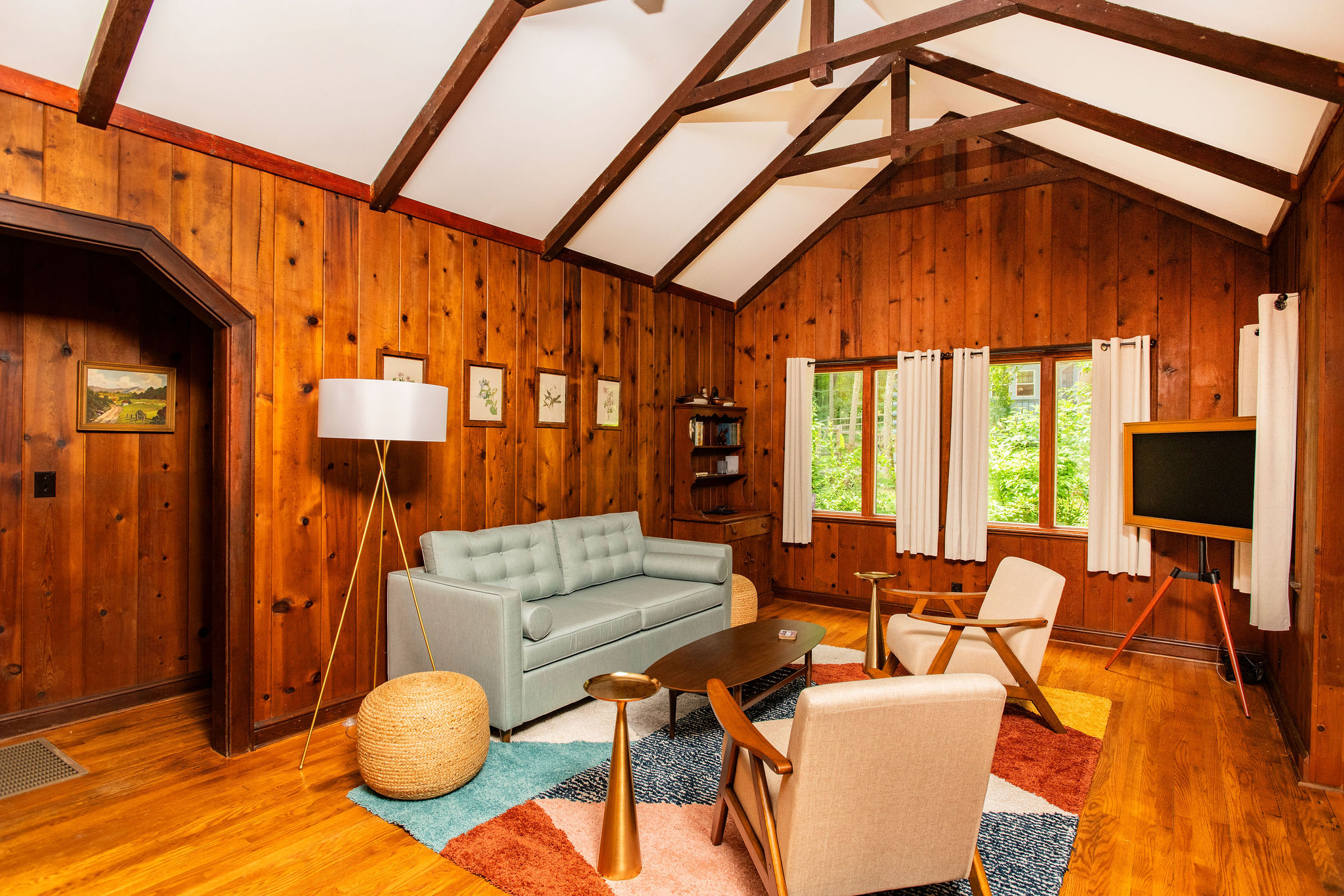 Cozy mid-century seating under soaring wood-beamed ceilings