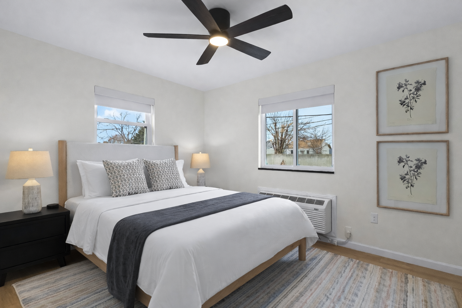 Bright, airy bedroom with a cozy bed, soft linens, ceiling fan, and natural light—creating a calm, comfortable space to rest and recharge.