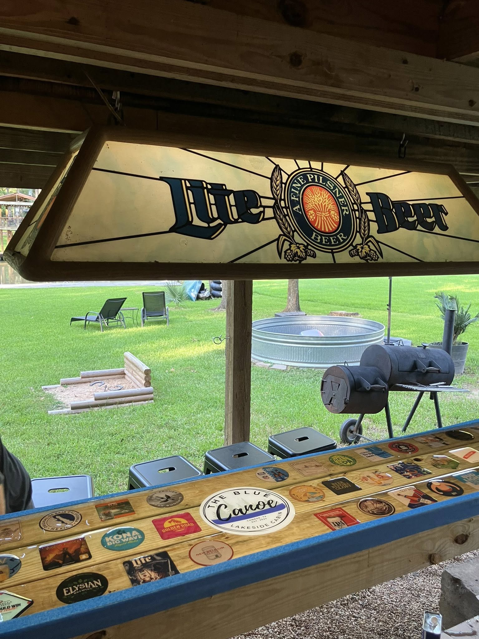 Downstairs bar area with vintage beer sign and custom coaster bar top.