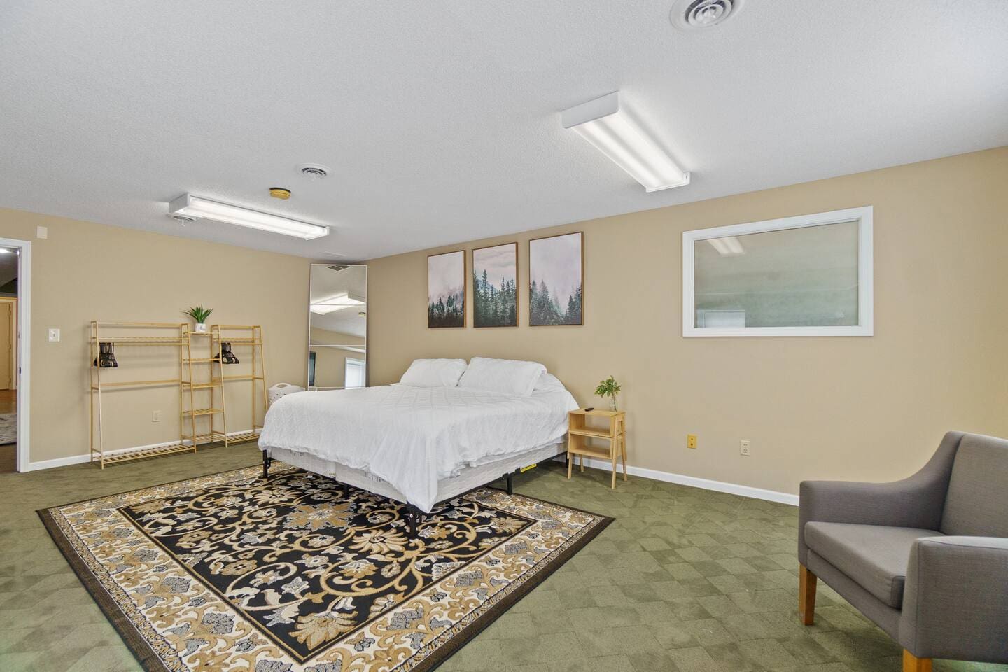 Spacious queen-sized bed with a soft carpet underneath, creating a cozy and comfortable retreat for a restful night's sleep.