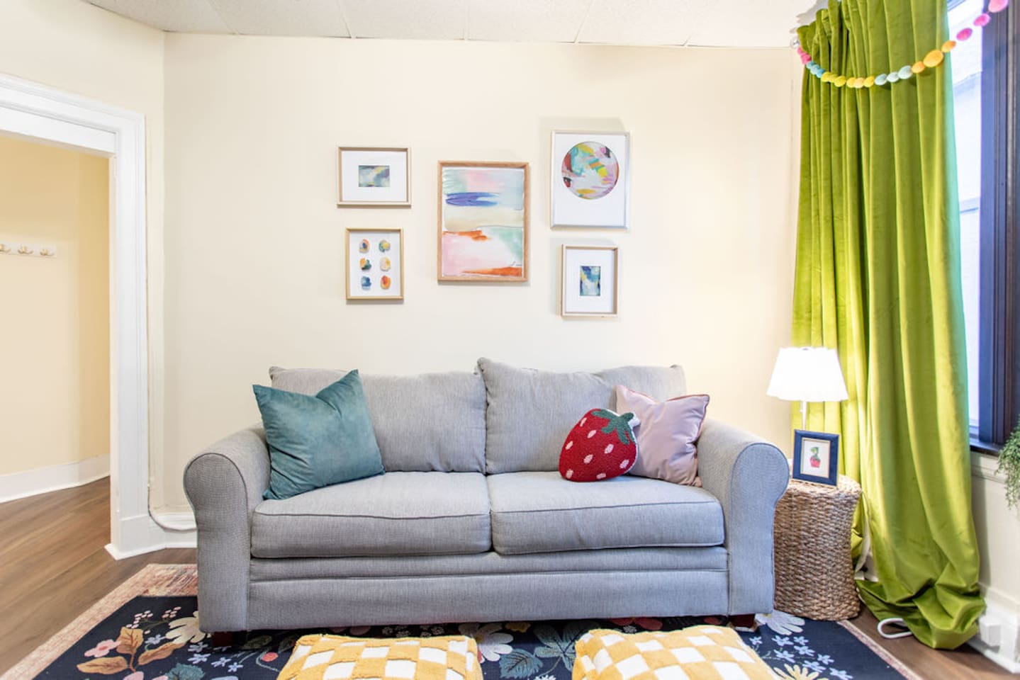 Bright and spacious living room featuring a comfortable sofa bed, perfect for relaxing or accommodating extra guests.