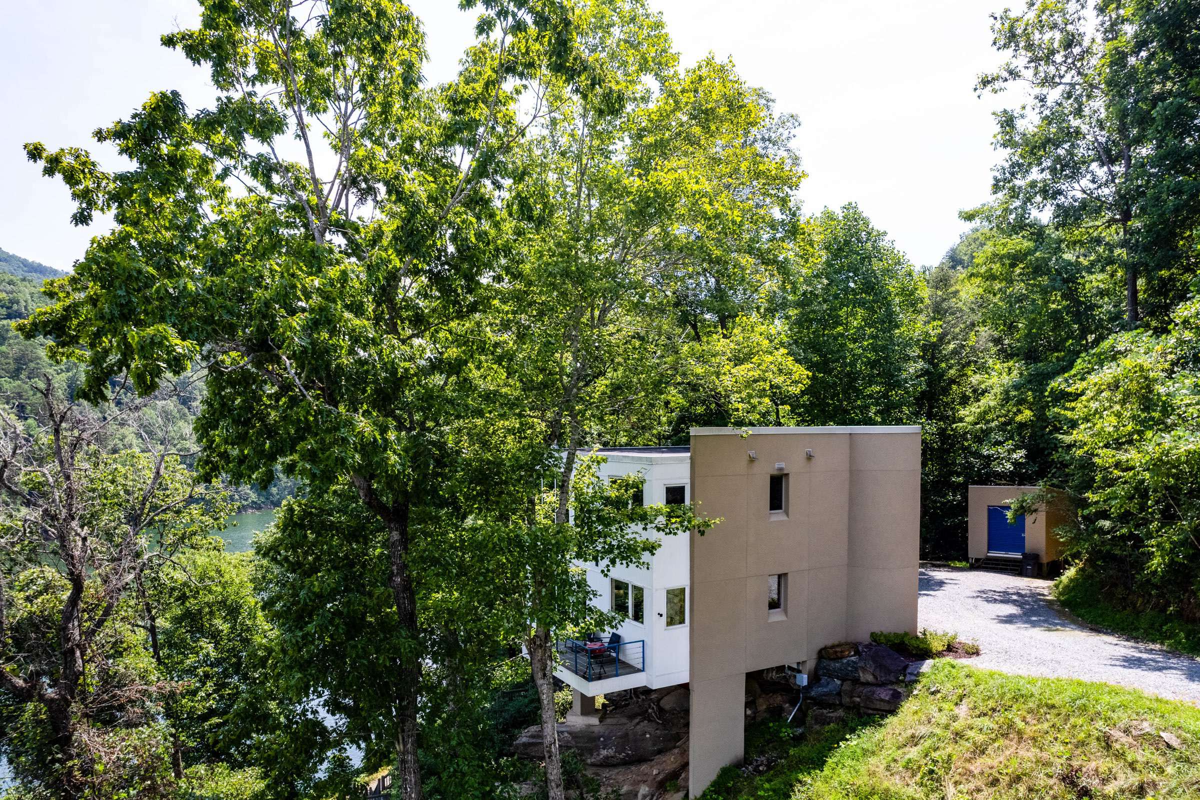 The side view of the home as you come down the gravel driveway