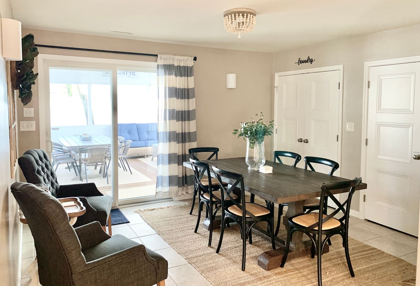 Enjoy family meals at our farmhouse-style dining table with seating for six. This bright space features stylish cross-back chairs, additional fireside seating, and sliding glass door access to the sunroom for an indoor-outdoor flow.