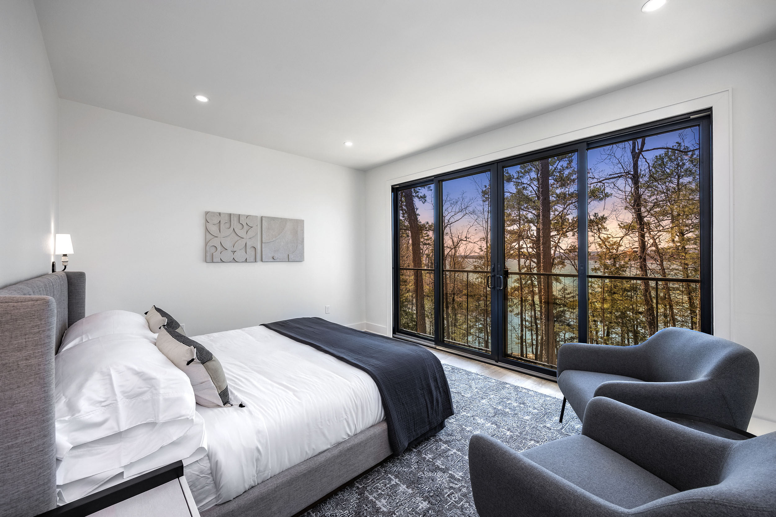 Wake up to peaceful treetop lake views in this serene king suite featuring modern comfort and direct view of the lake through the sliding glass balcony doors that bring the outside in.