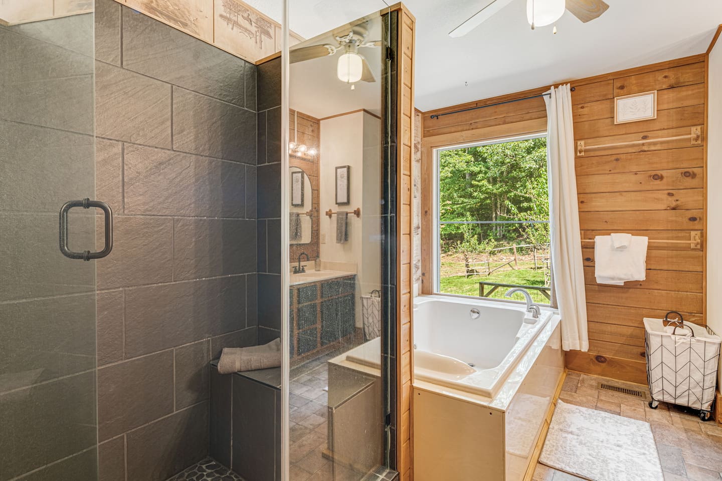 The main level bathroom features a walk in shower and a large soaking tub.