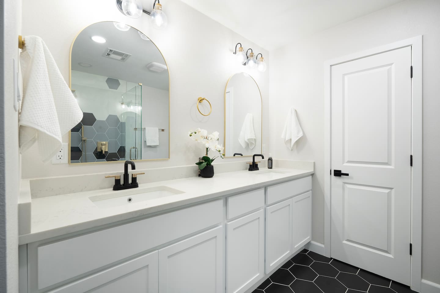 Spacious double vanity with modern finishes, elegant mirrors, and plenty of room to get ready in comfort and style