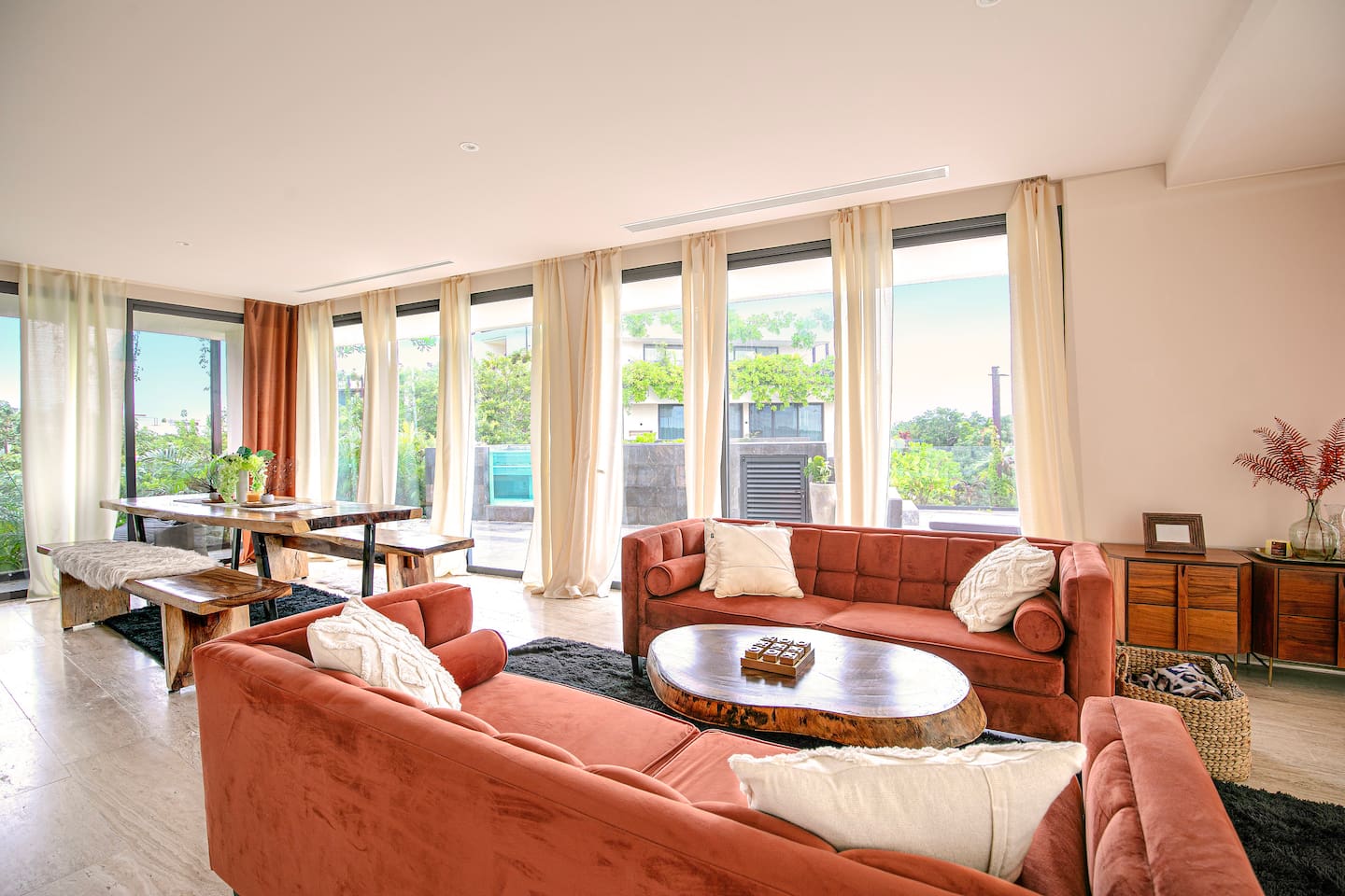 Living and dinning area with floor to ceiling opening doors to balconies on both sides, and to your private pool 