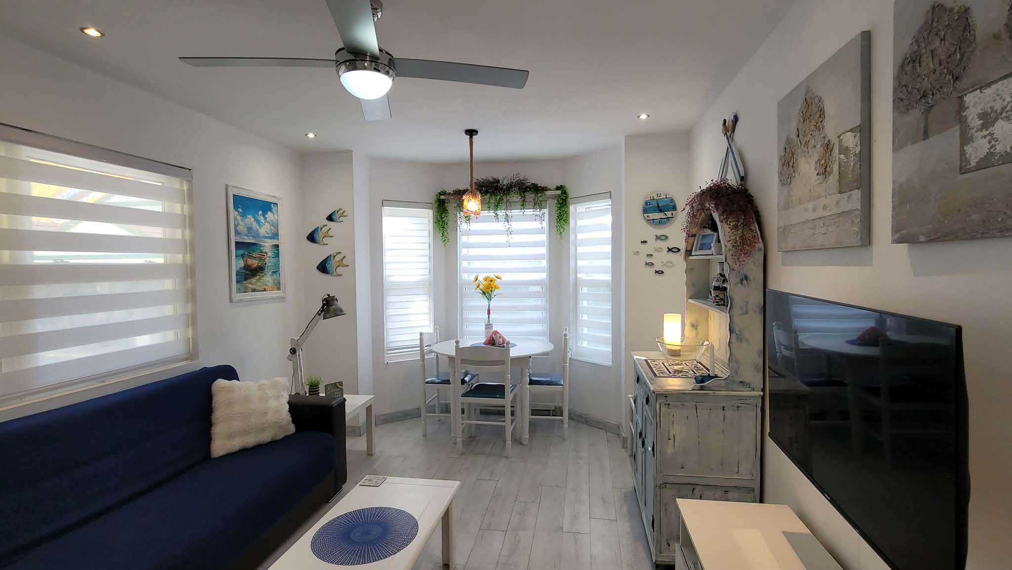 Living area with Smart TV, ceiling Fan, and Air Conditioner