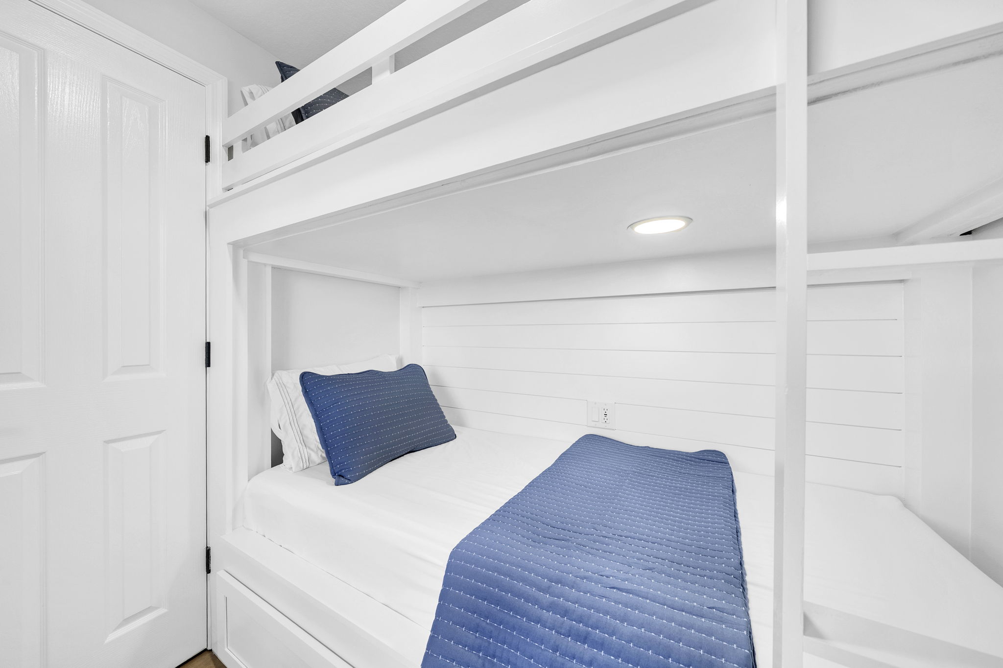 Custom-built Twin XL bunks offer a cozy, space-saving retreat—perfect for kids or extra guests to rest and recharge.