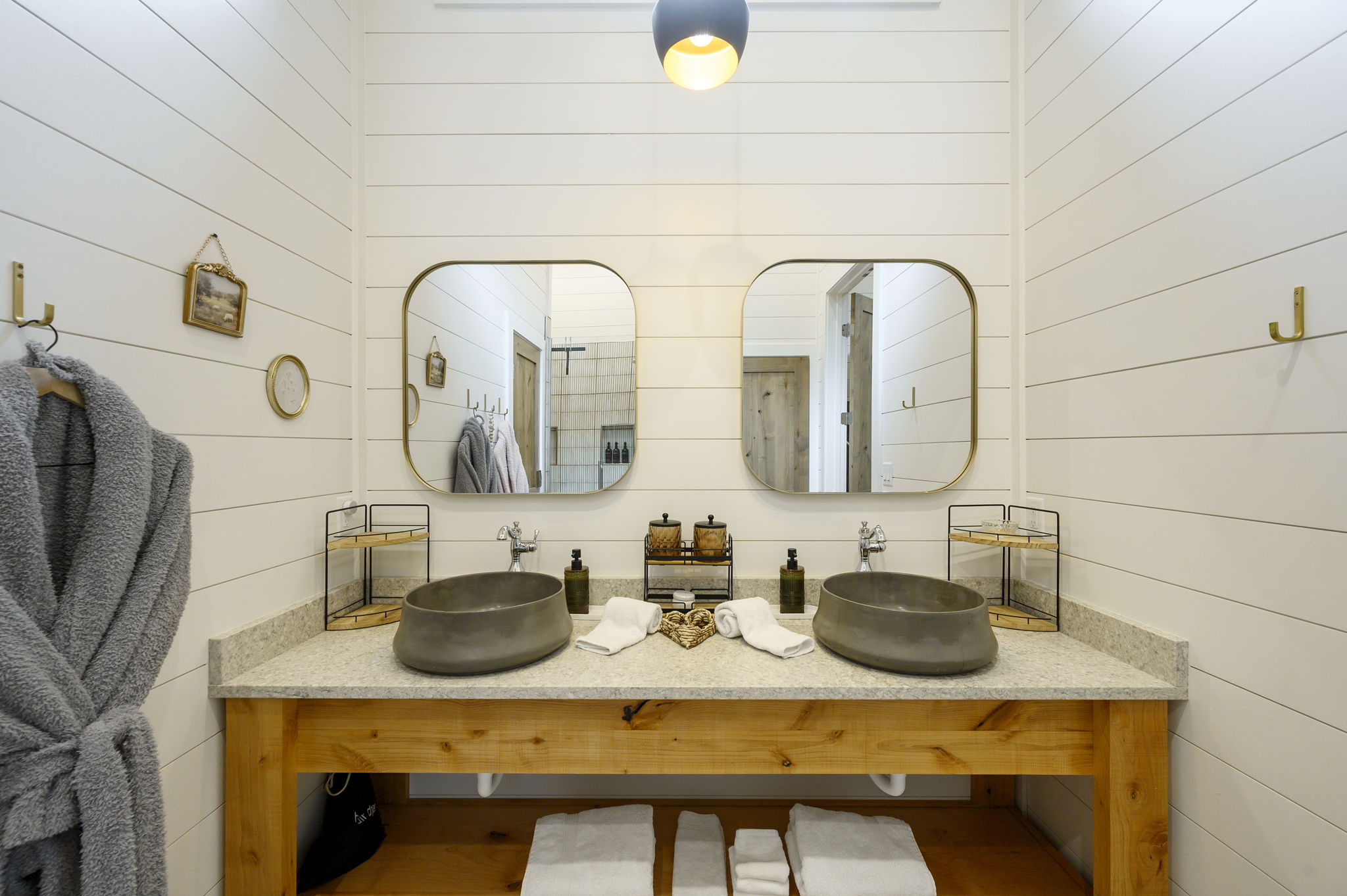The primary ensuite bathroom offers a warm, spa-like experience with high-end finishes, luxurious touches, and a serene atmosphere designed for comfort and relaxation.