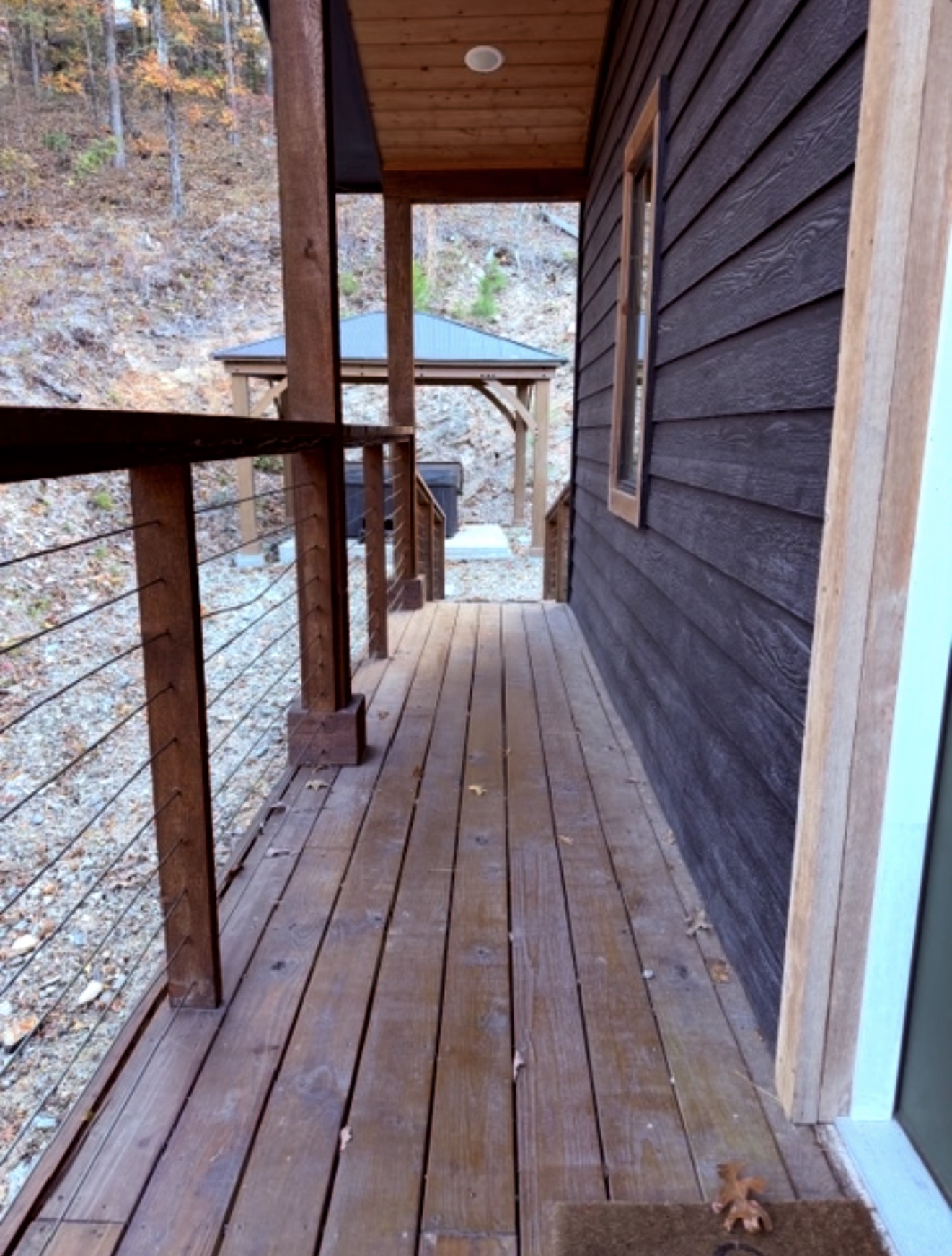 Your private escape continues outdoors — stroll to the hot tub tucked beneath the trees